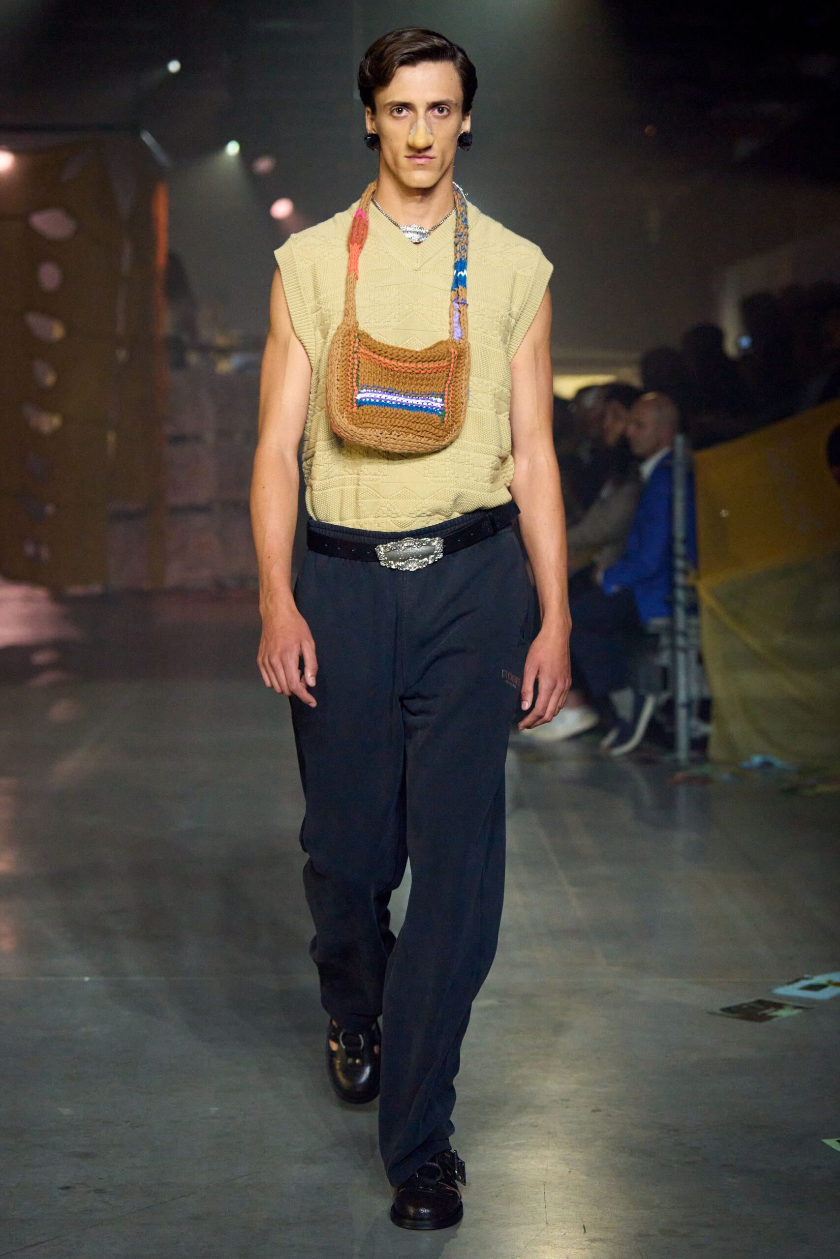 beige sleeveless top with black pants