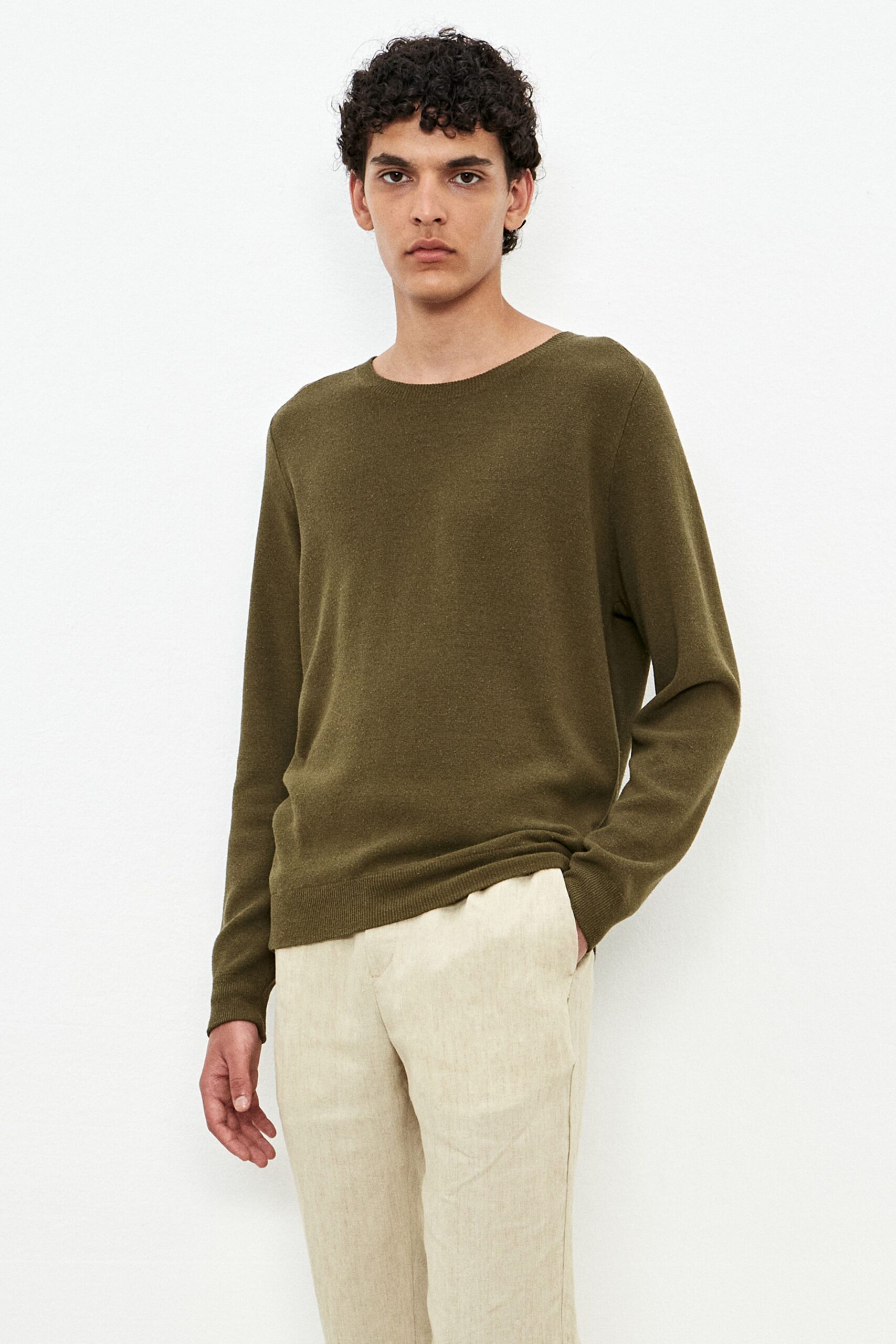 green relaxed sweater and beige pants