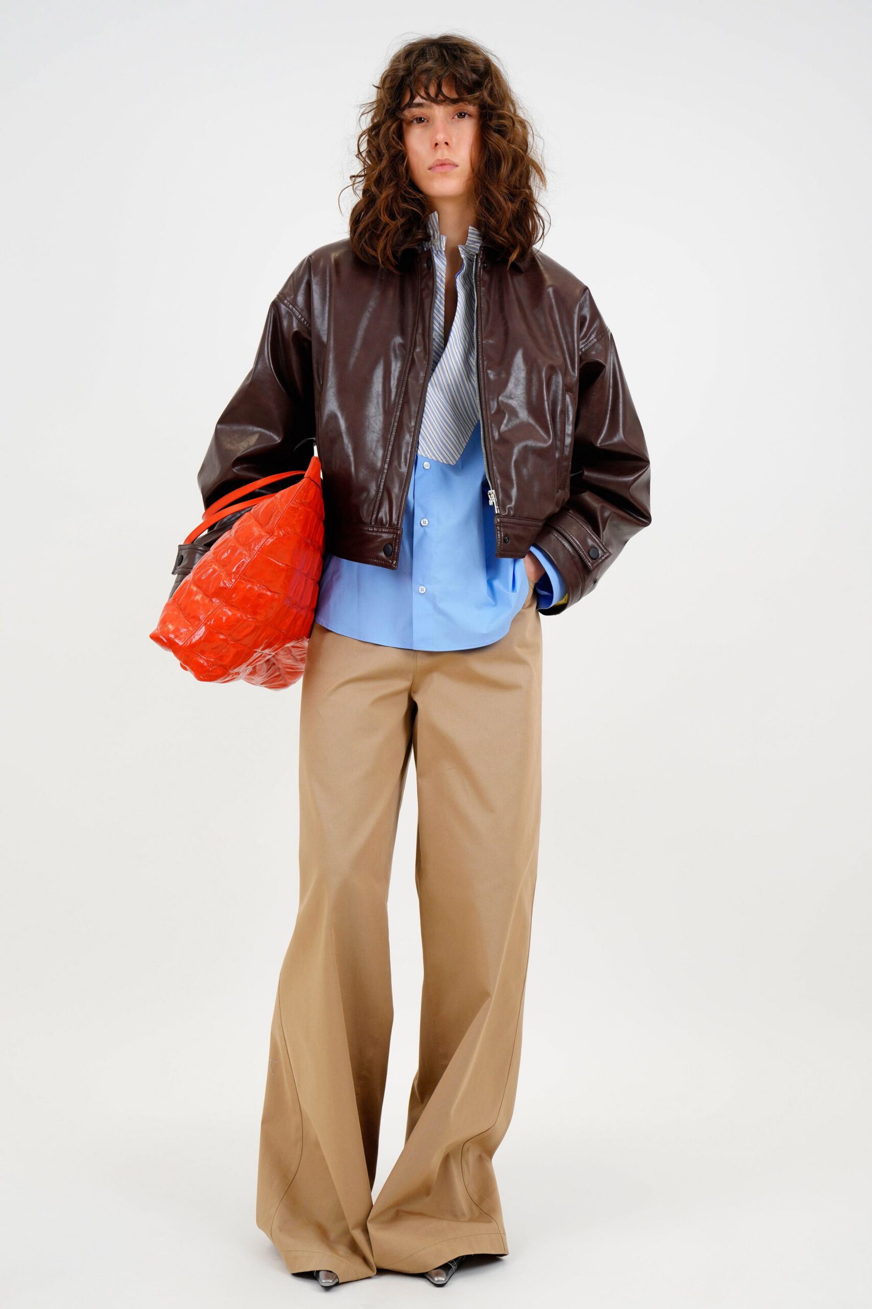 brown leather jacket blue shirt beige pants