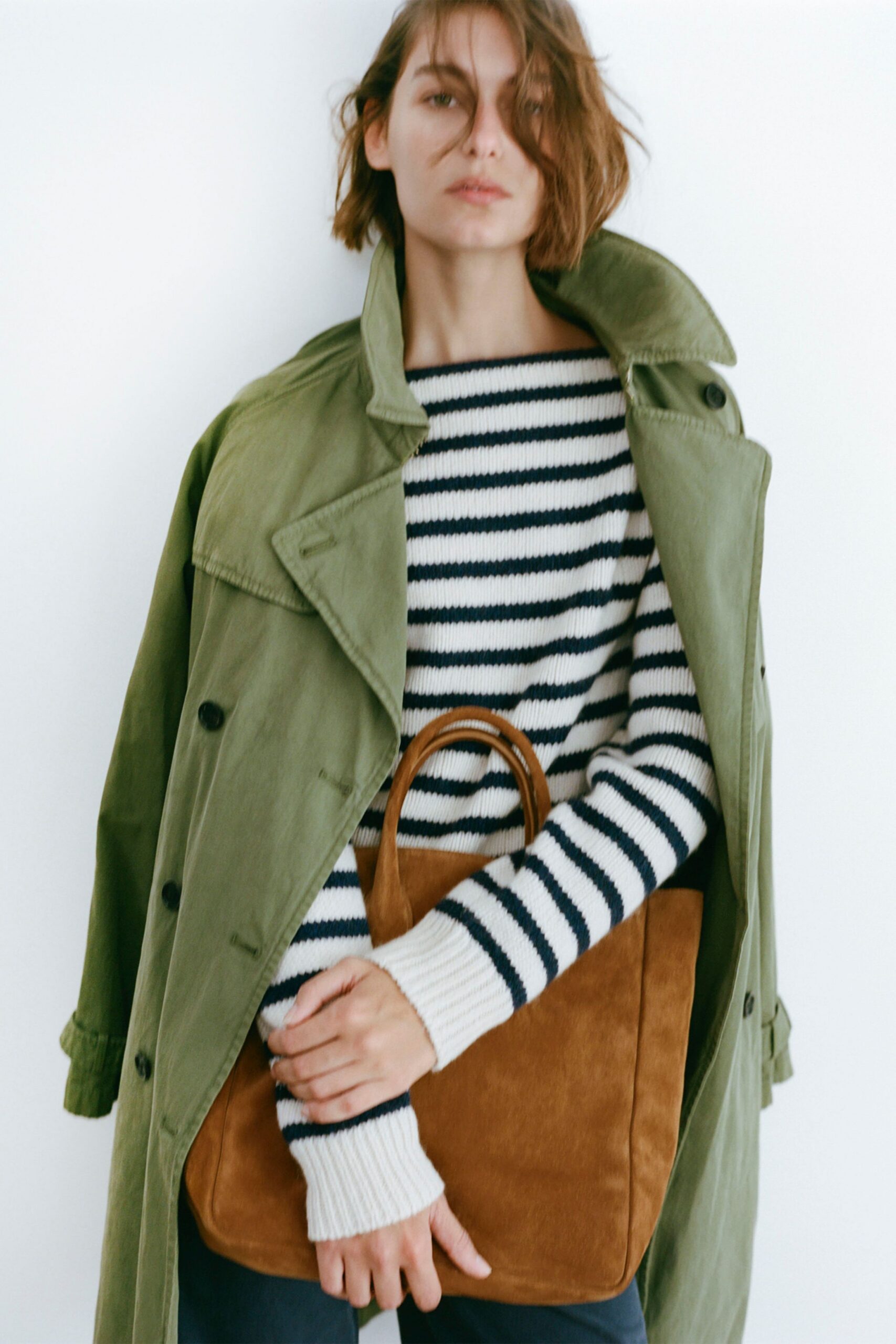 green coat with striped sweater