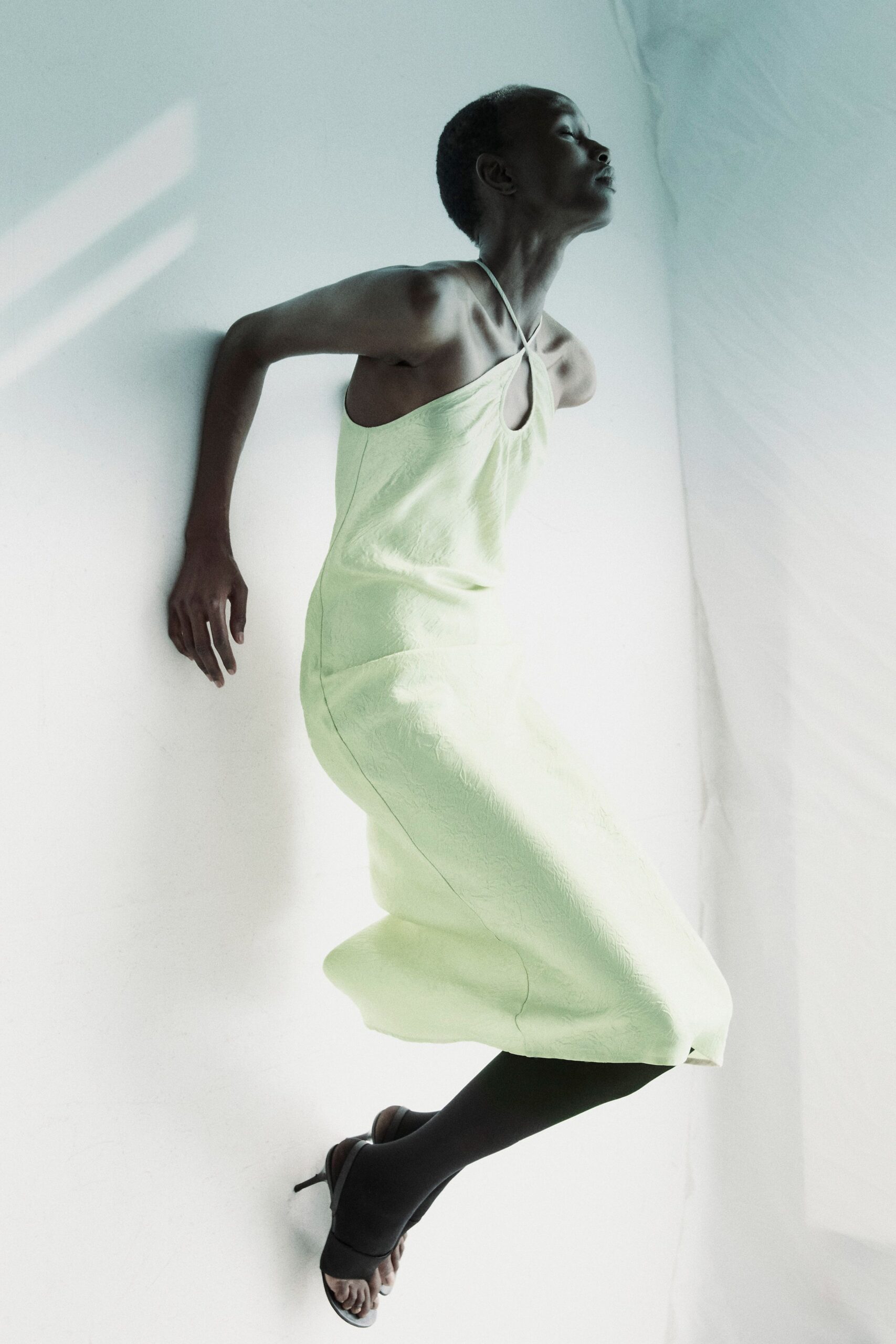 fitted green midi dress with black shoes