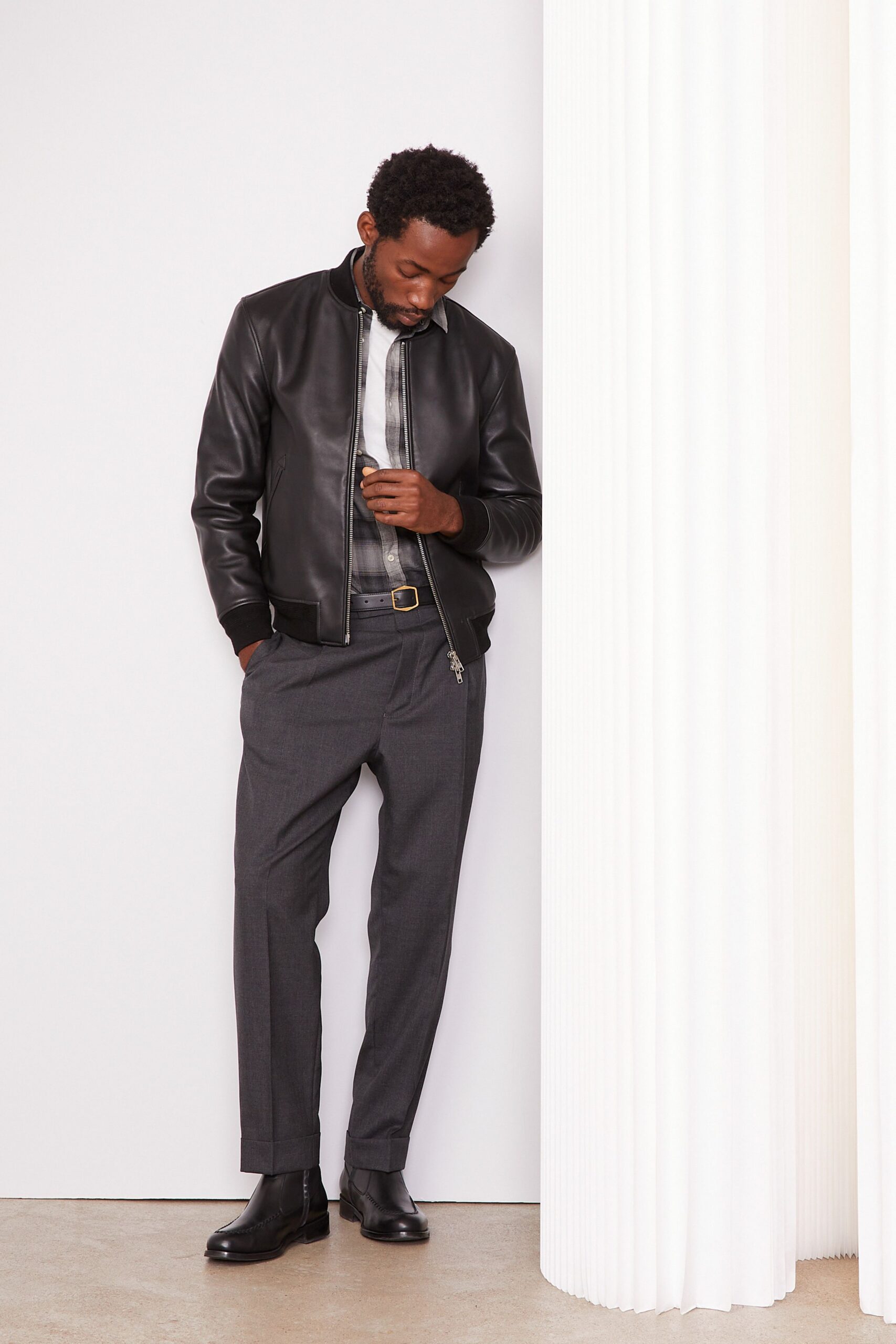 black leather jacket with gray pants