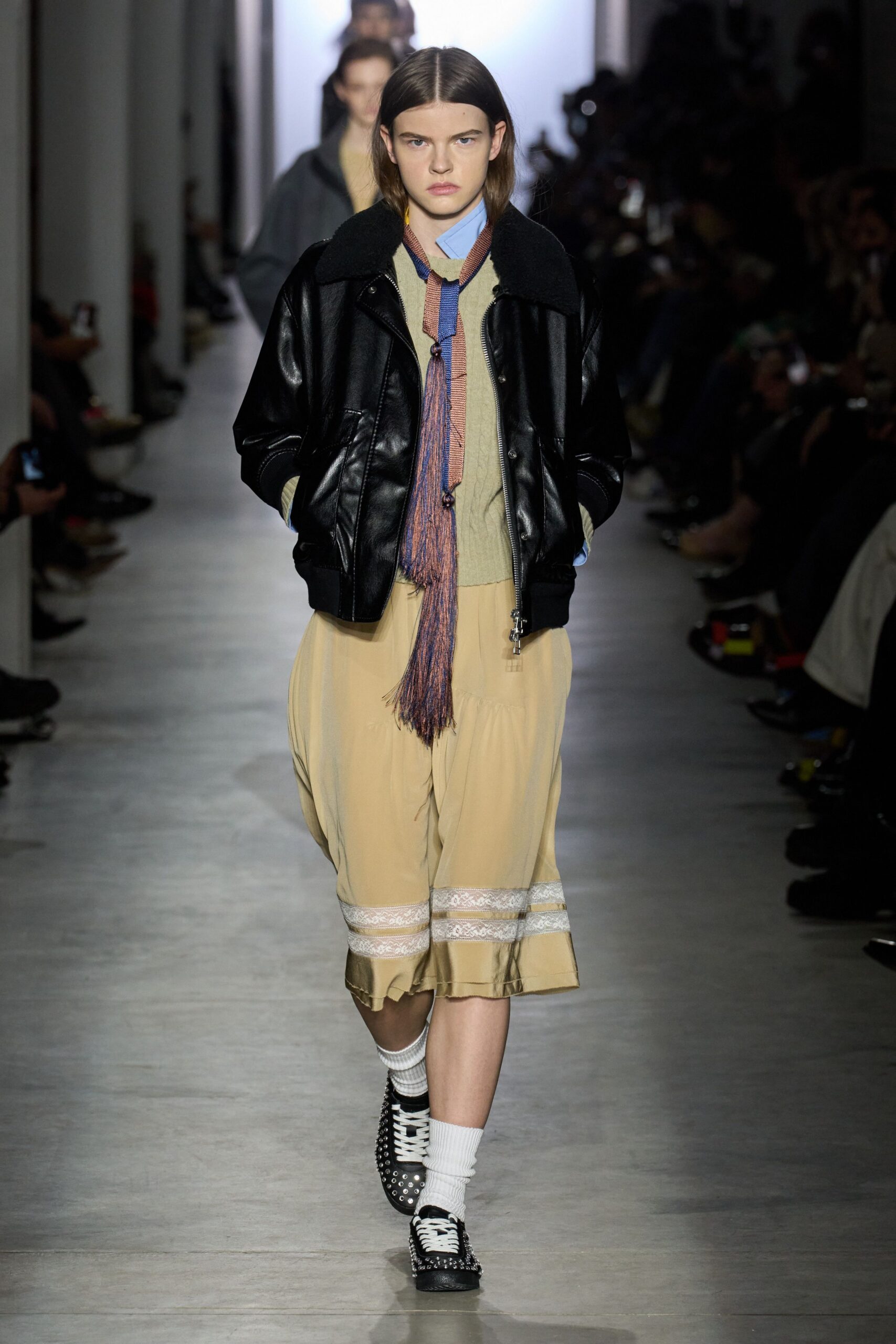 black leather jacket with beige skirt
