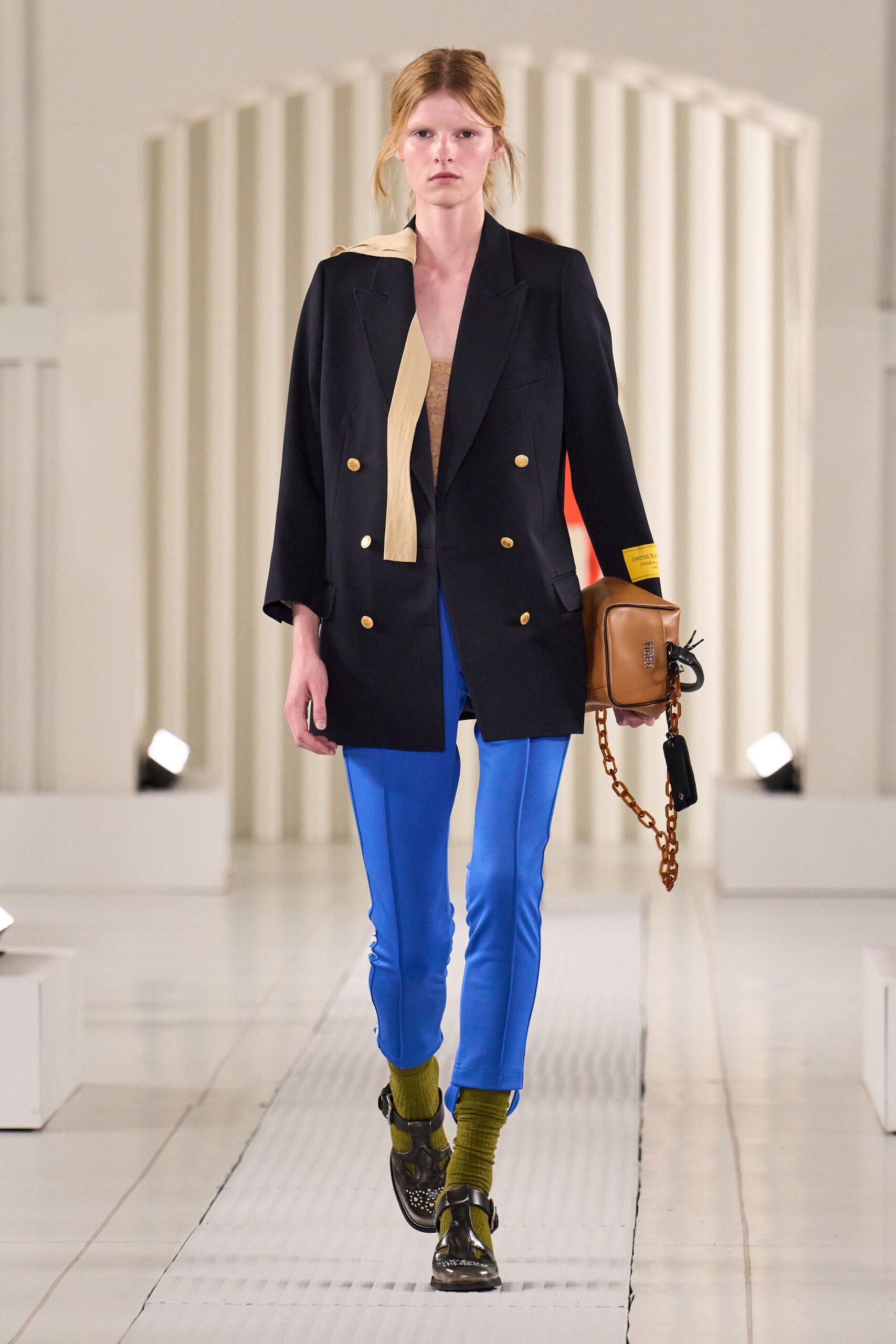 black blazer beige top blue pants