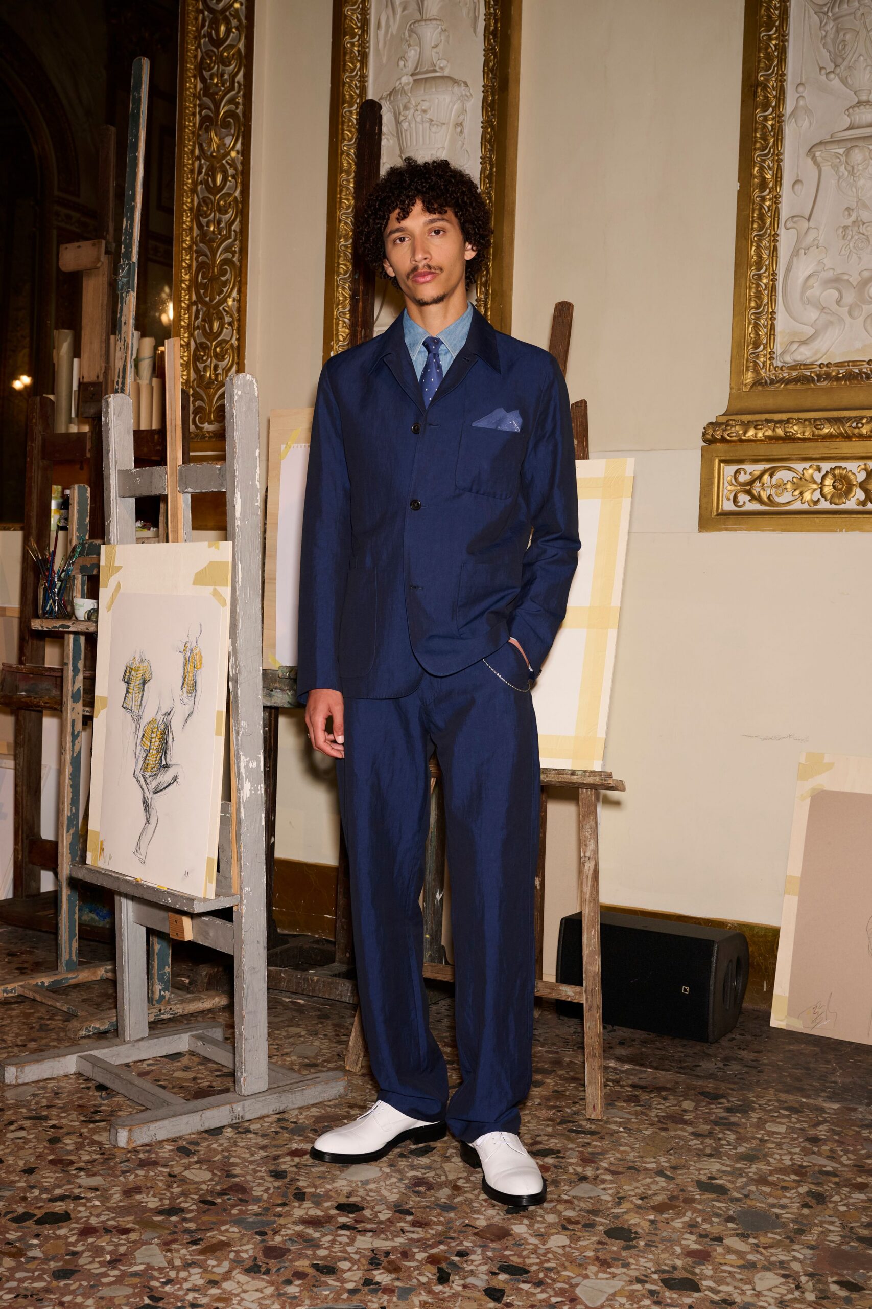 blue tailored suit with white shoes