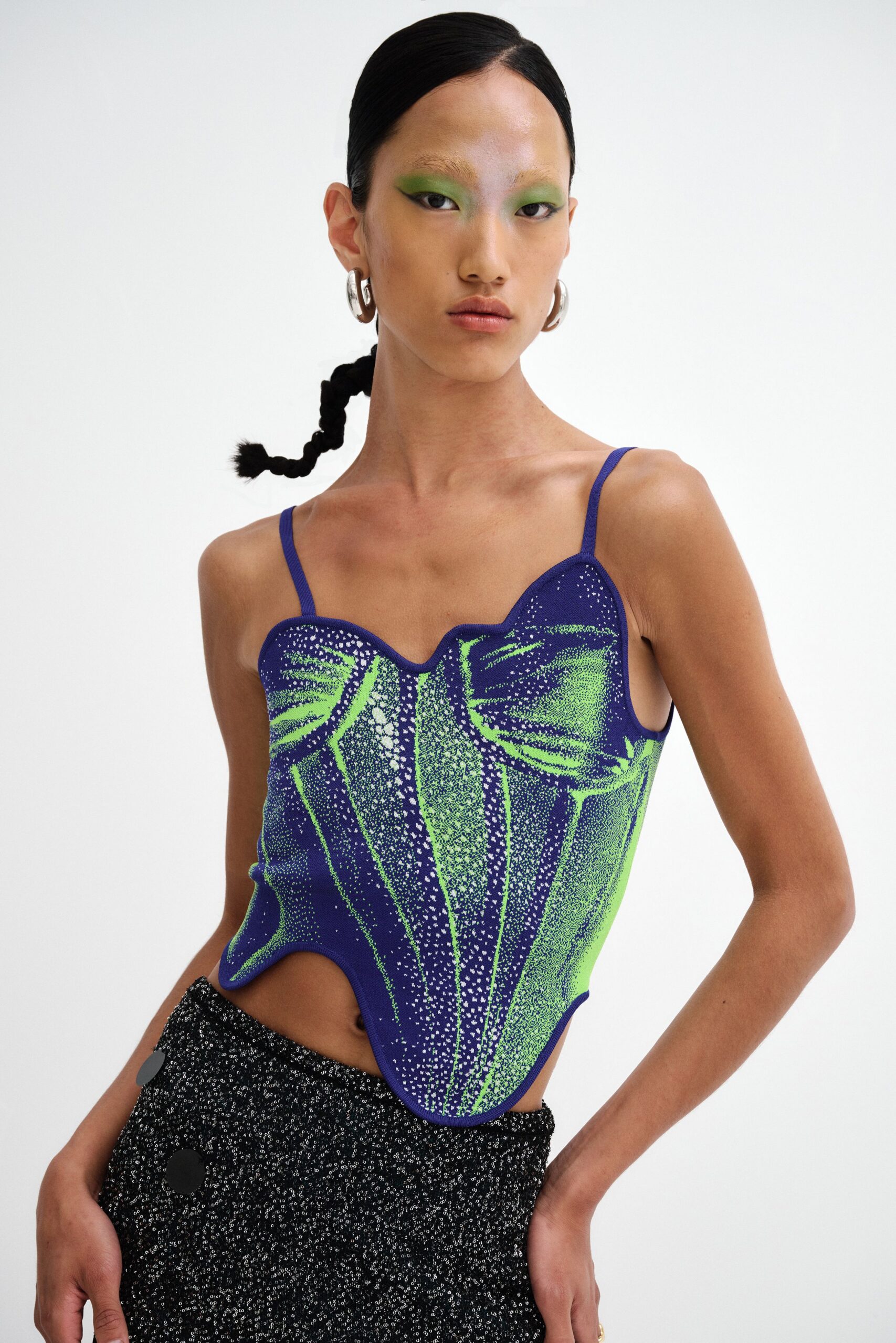 blue and green fitted top with black pants