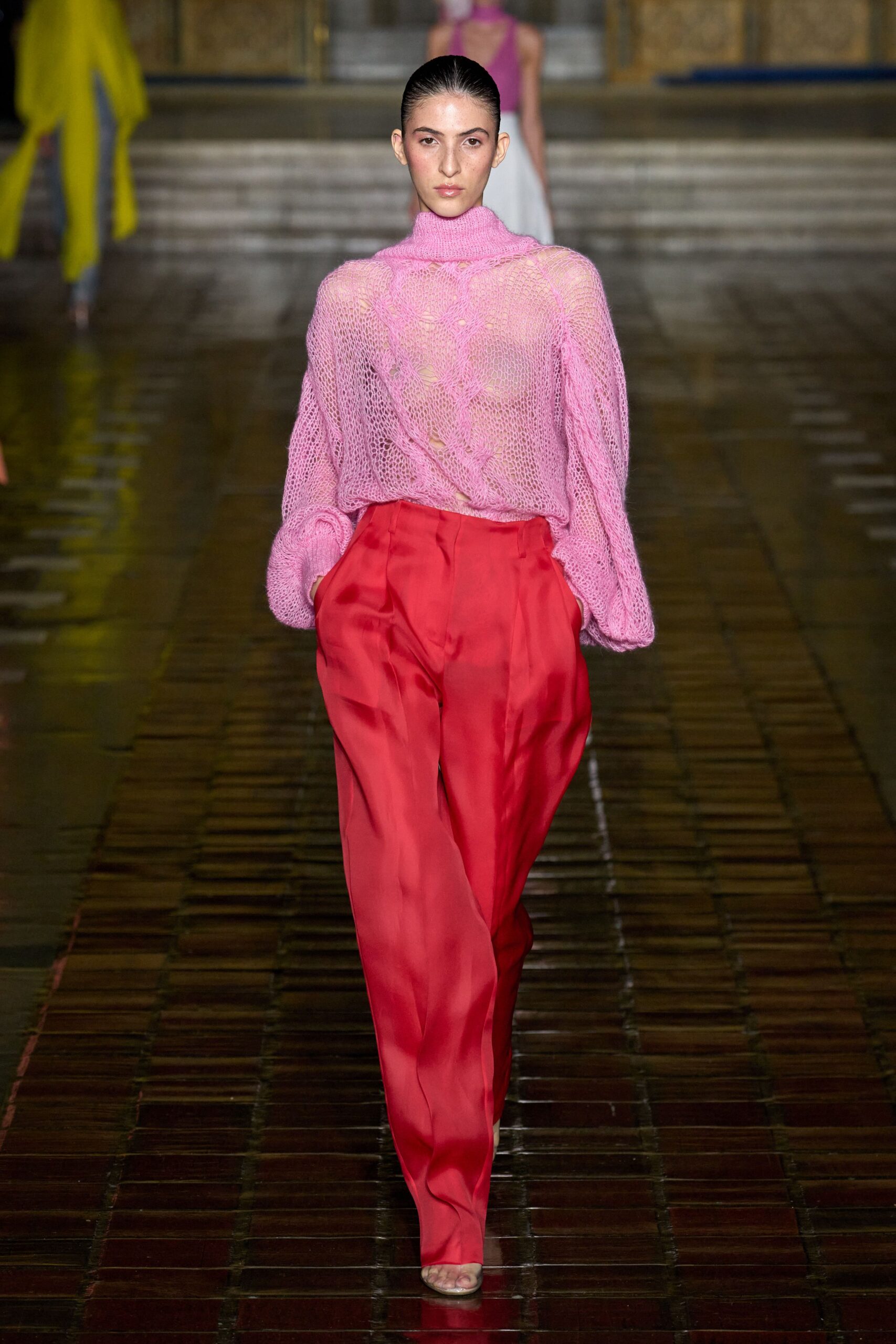 pink knit top and red pants