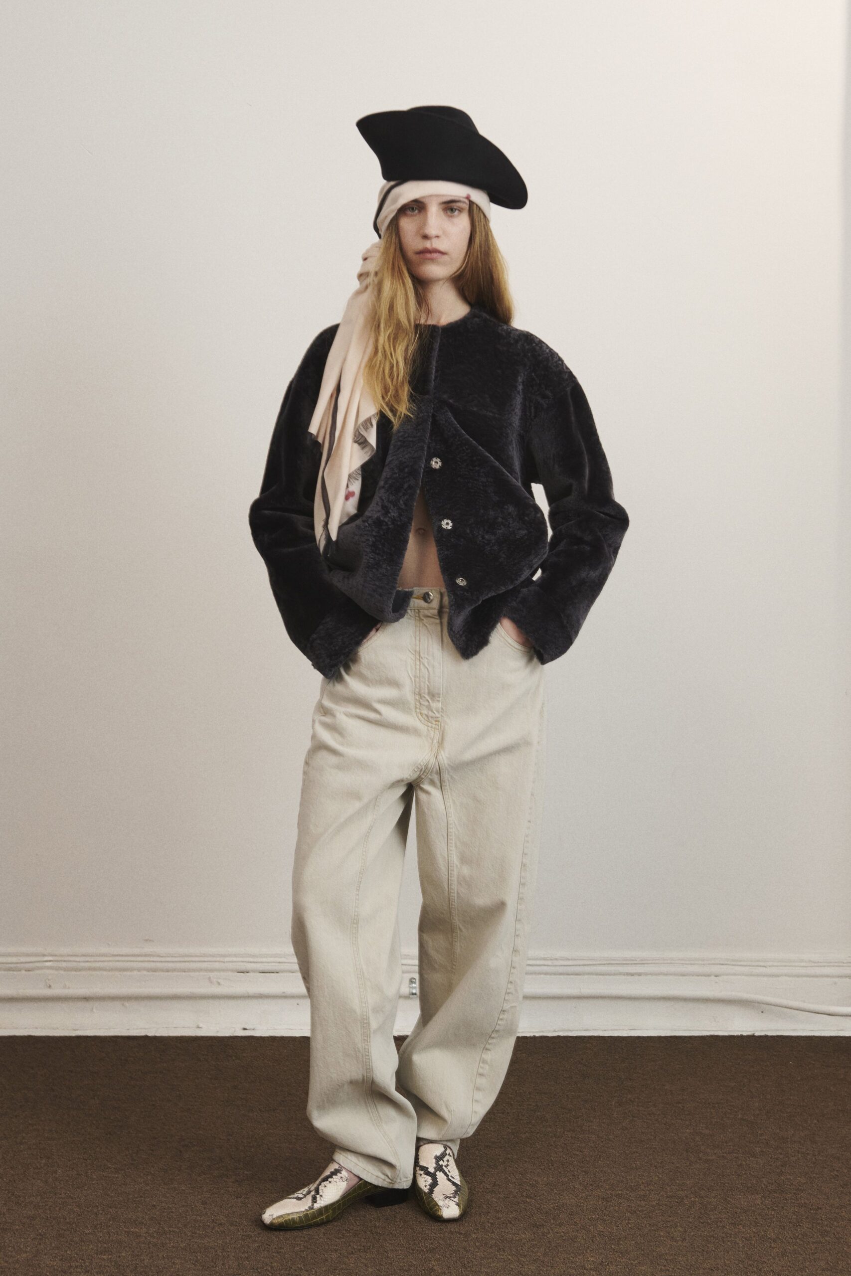 black faux-fur jacket with beige top