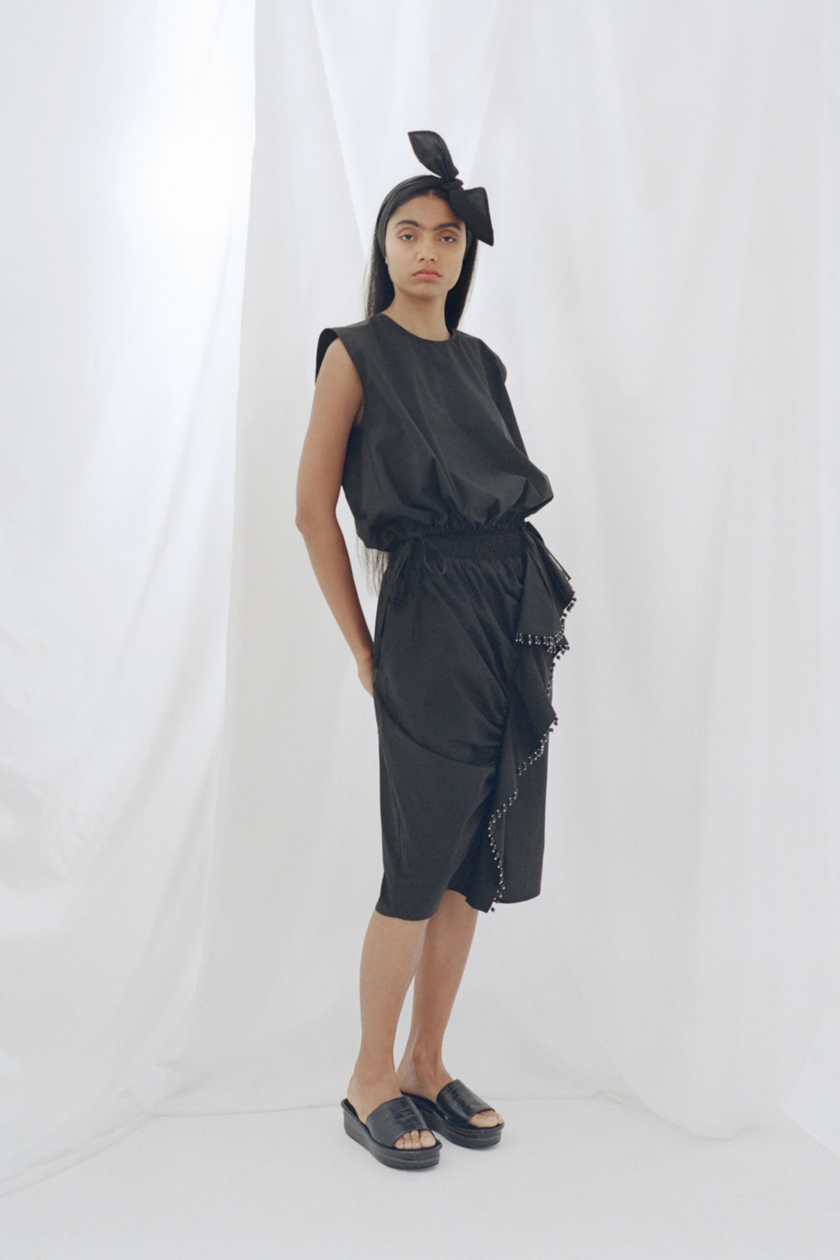 black cotton asymmetric fitted zippered midi skirt
