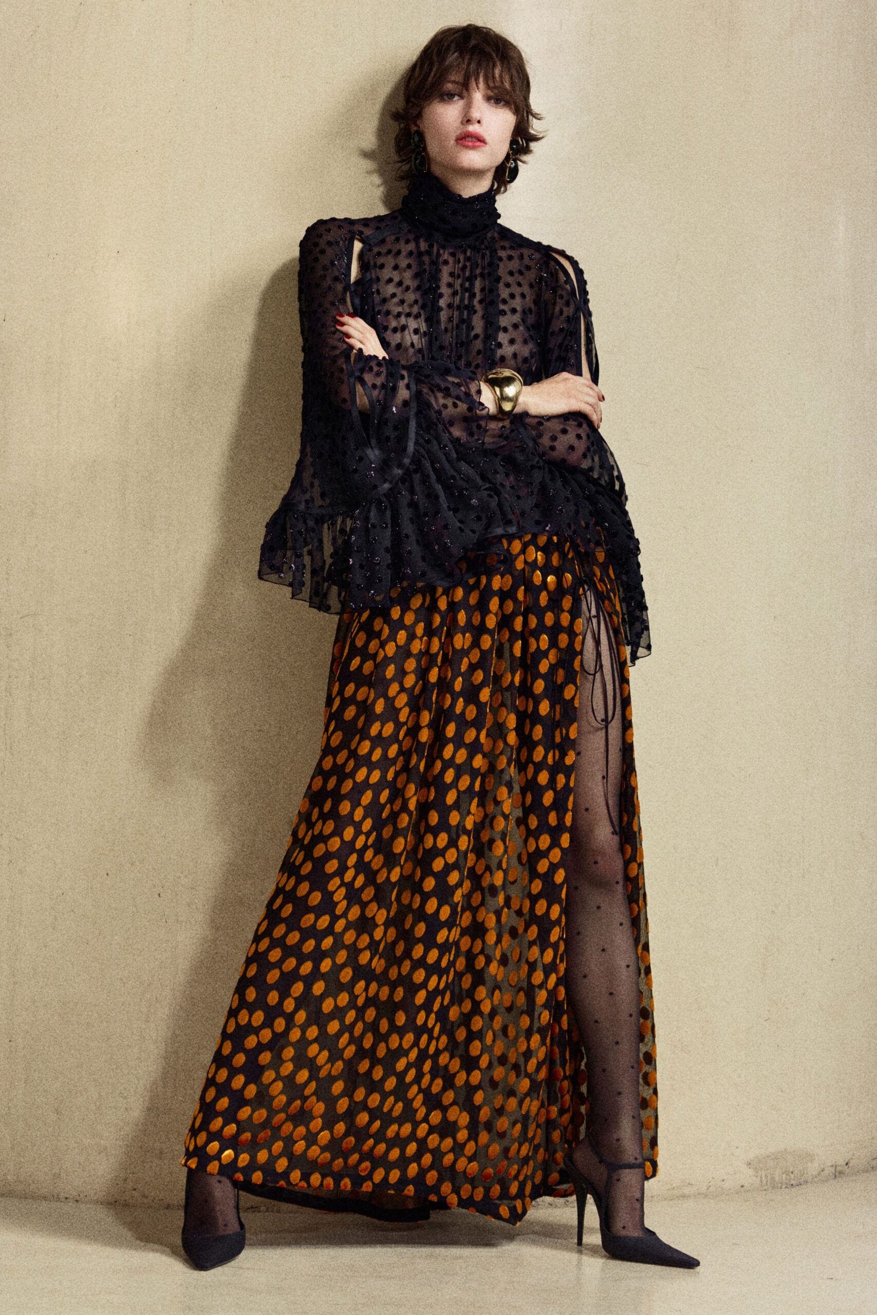 black polka-dot blouse with orange skirt