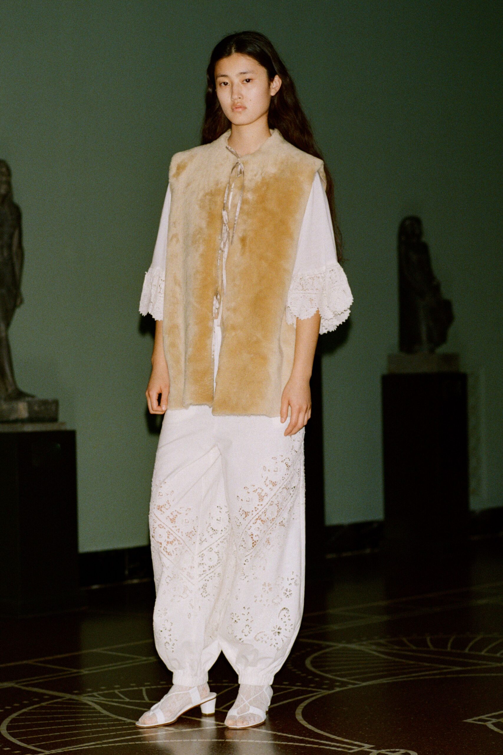 beige faux-fur vest with white outfit
