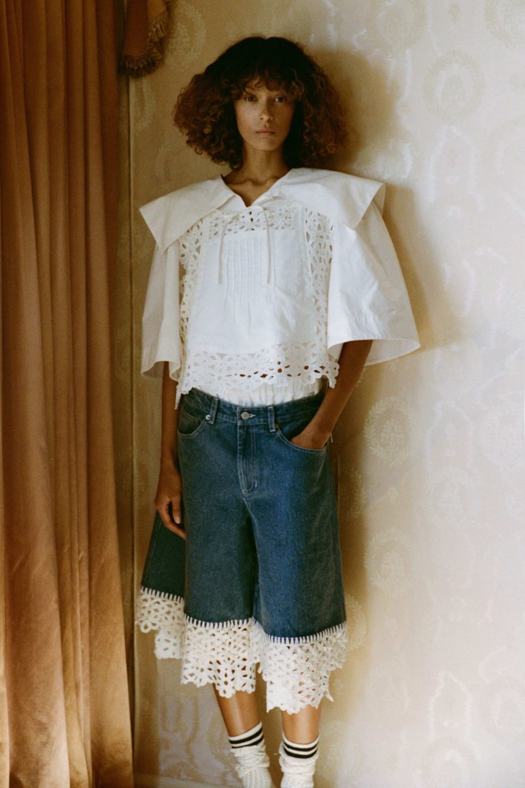 white embroidered top with denim shorts