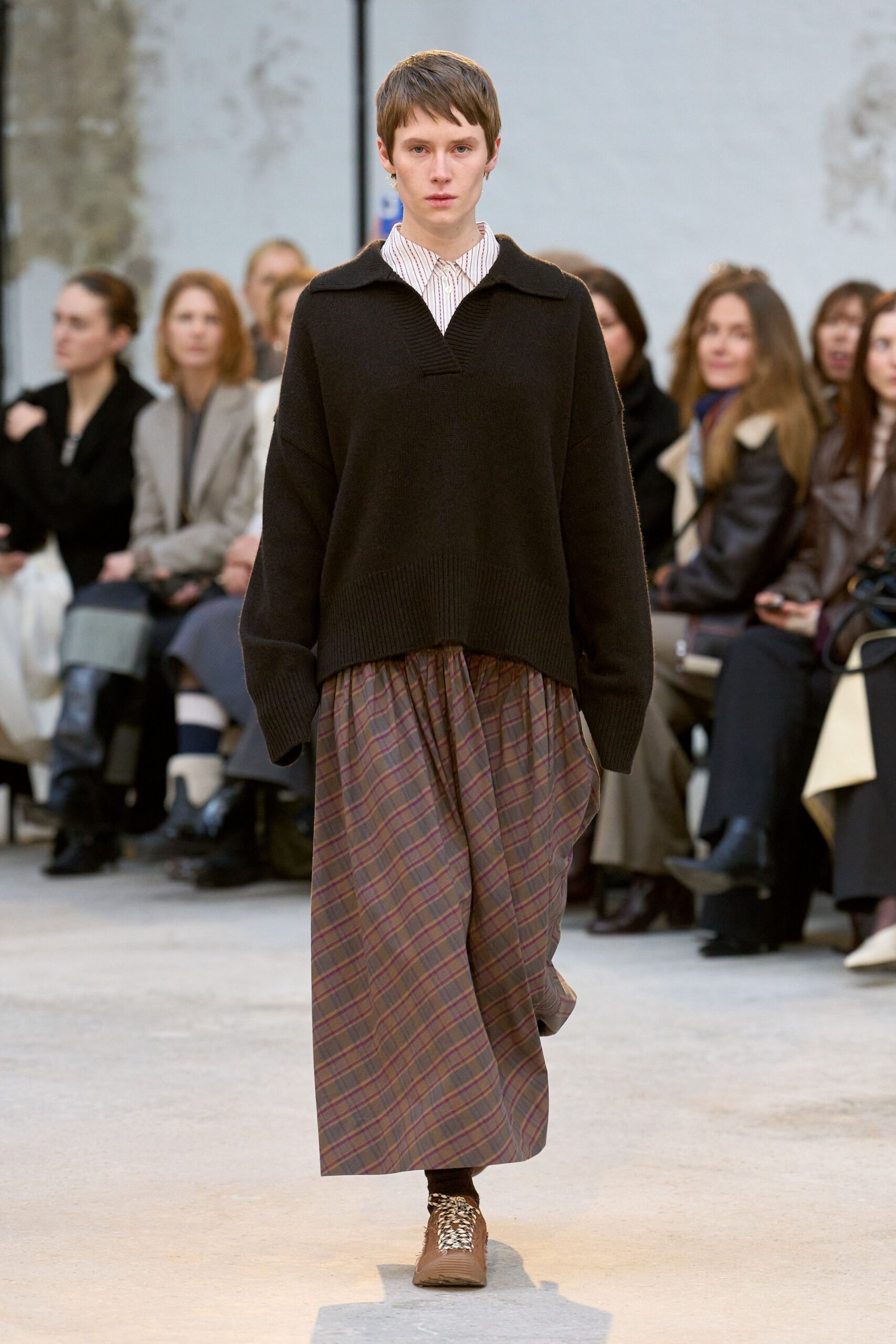 black oversized sweater with plaid skirt