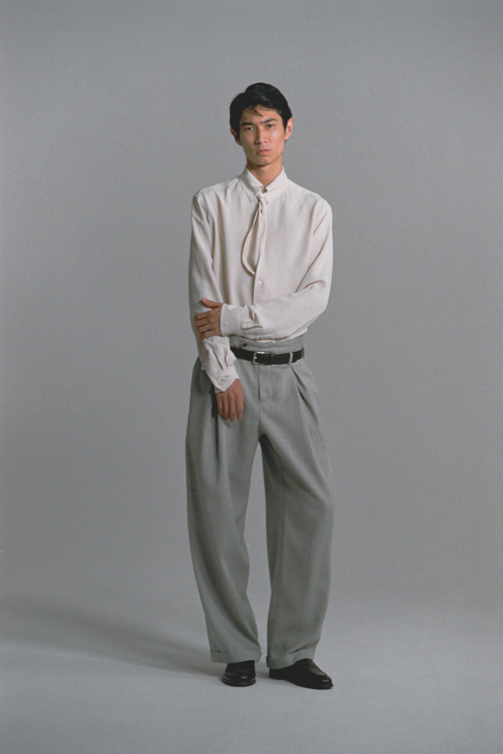 white relaxed shirt gray pants