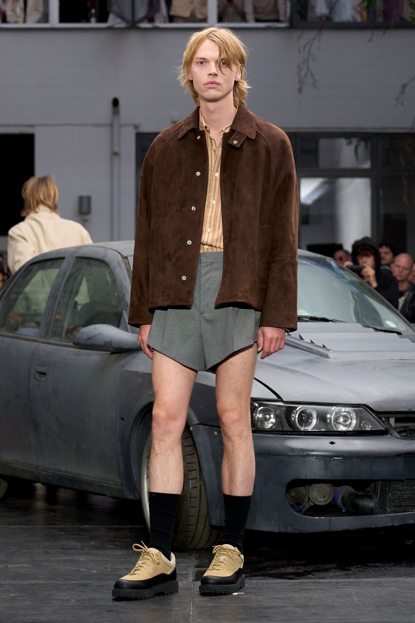 brown suede jacket beige shirt gray shorts