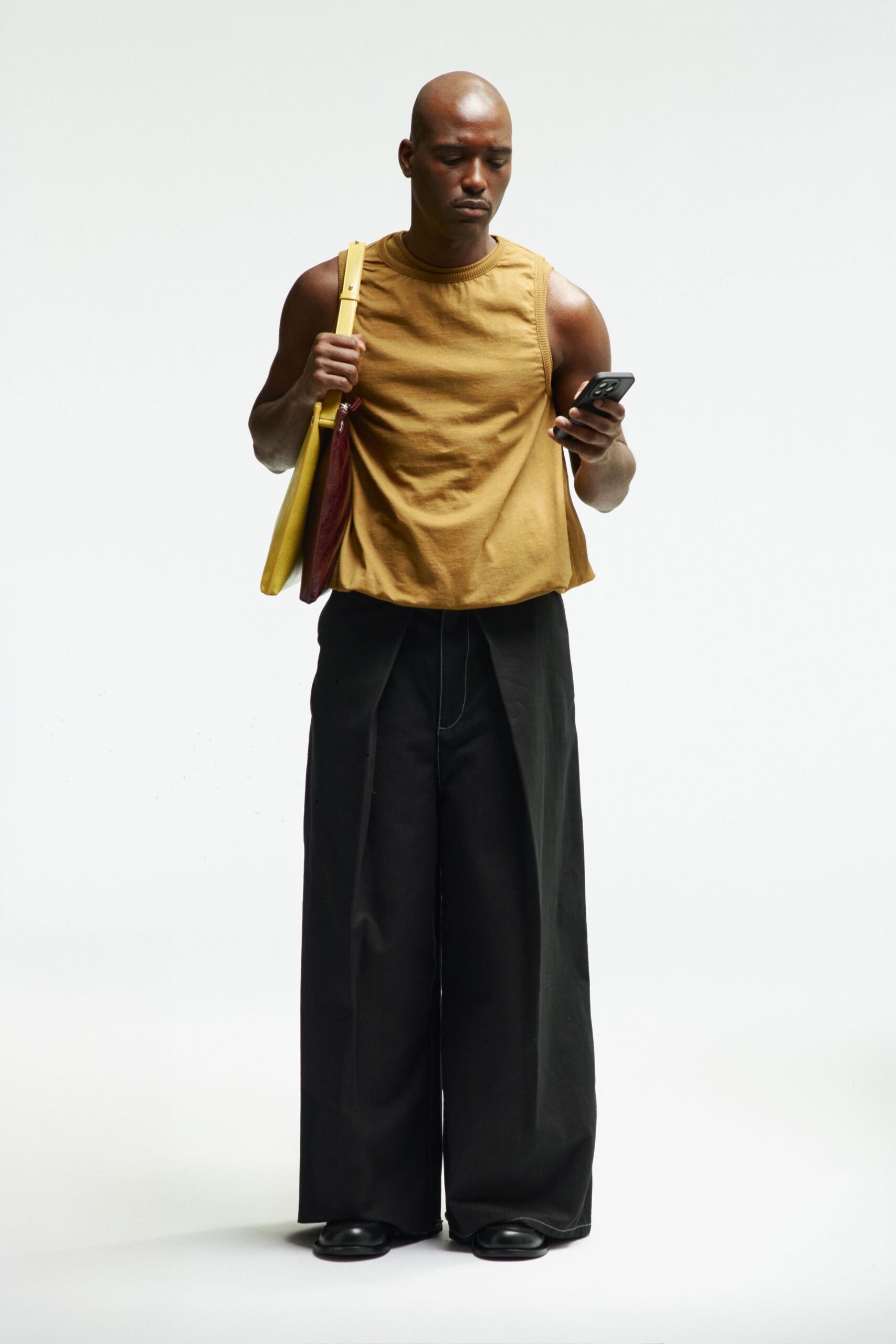 brown sleeveless top with black pants