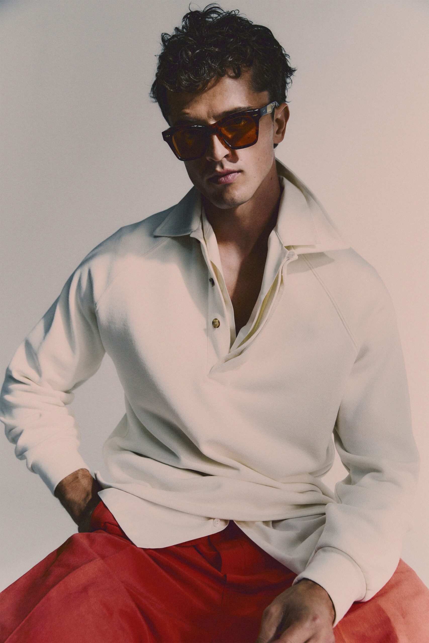 white relaxed shirt with red pants