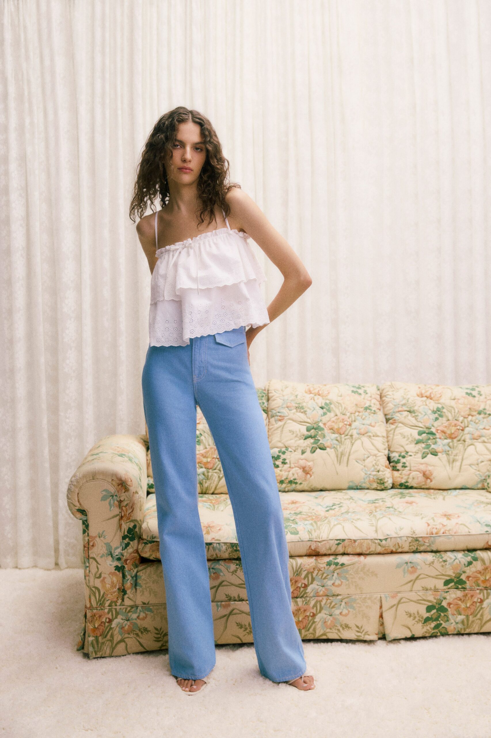 white ruffled top blue pants