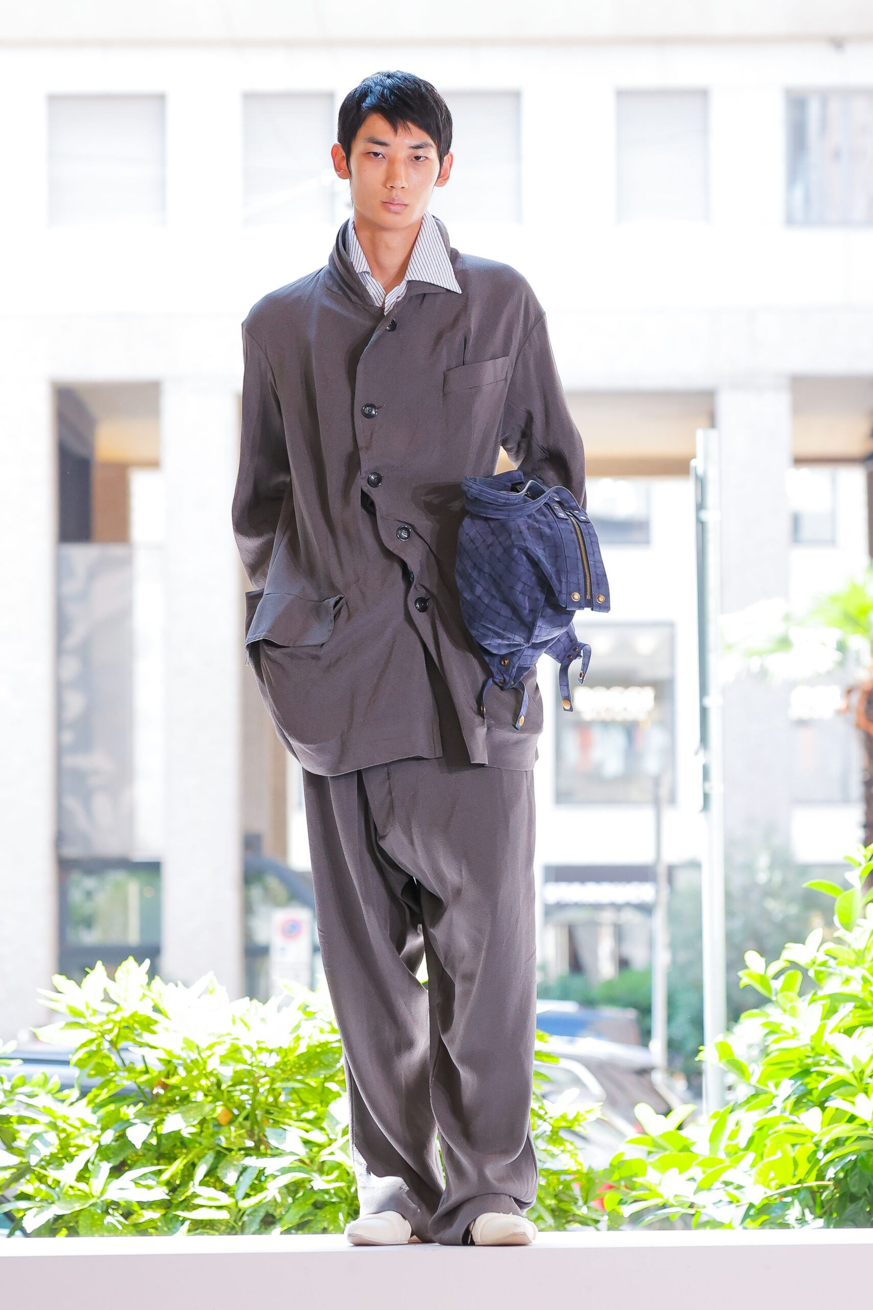 gray relaxed suit with blue bag