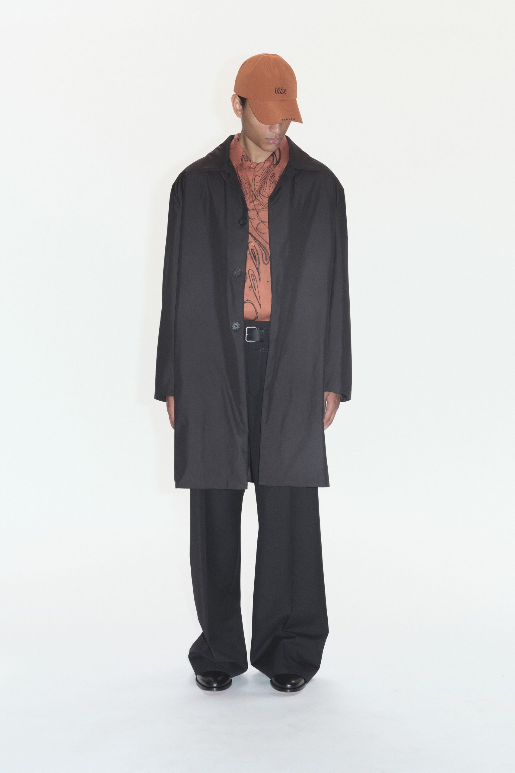 black coat orange shirt relaxed pants