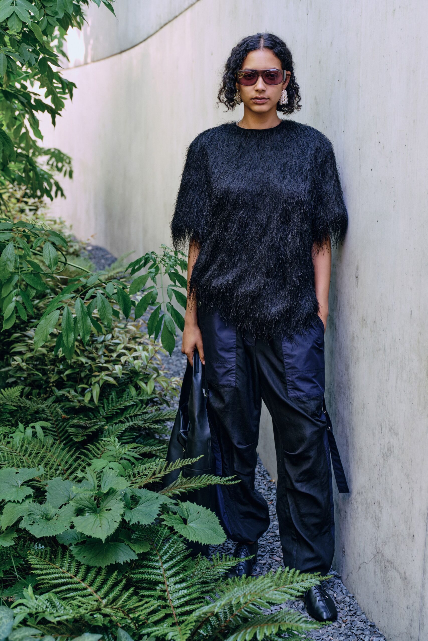black fringed top with cargo pants