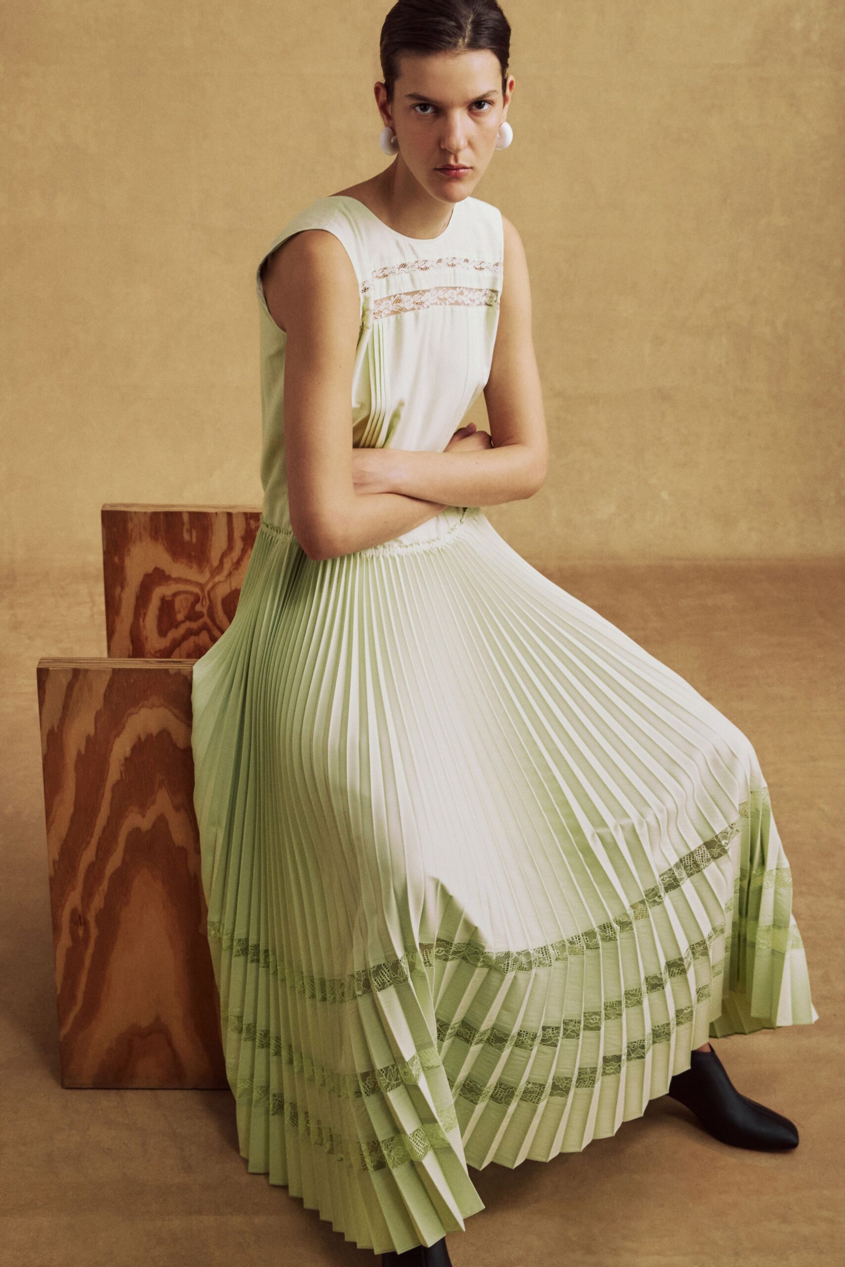 green silk sleeveless high-neck fitted pleated maxi dress