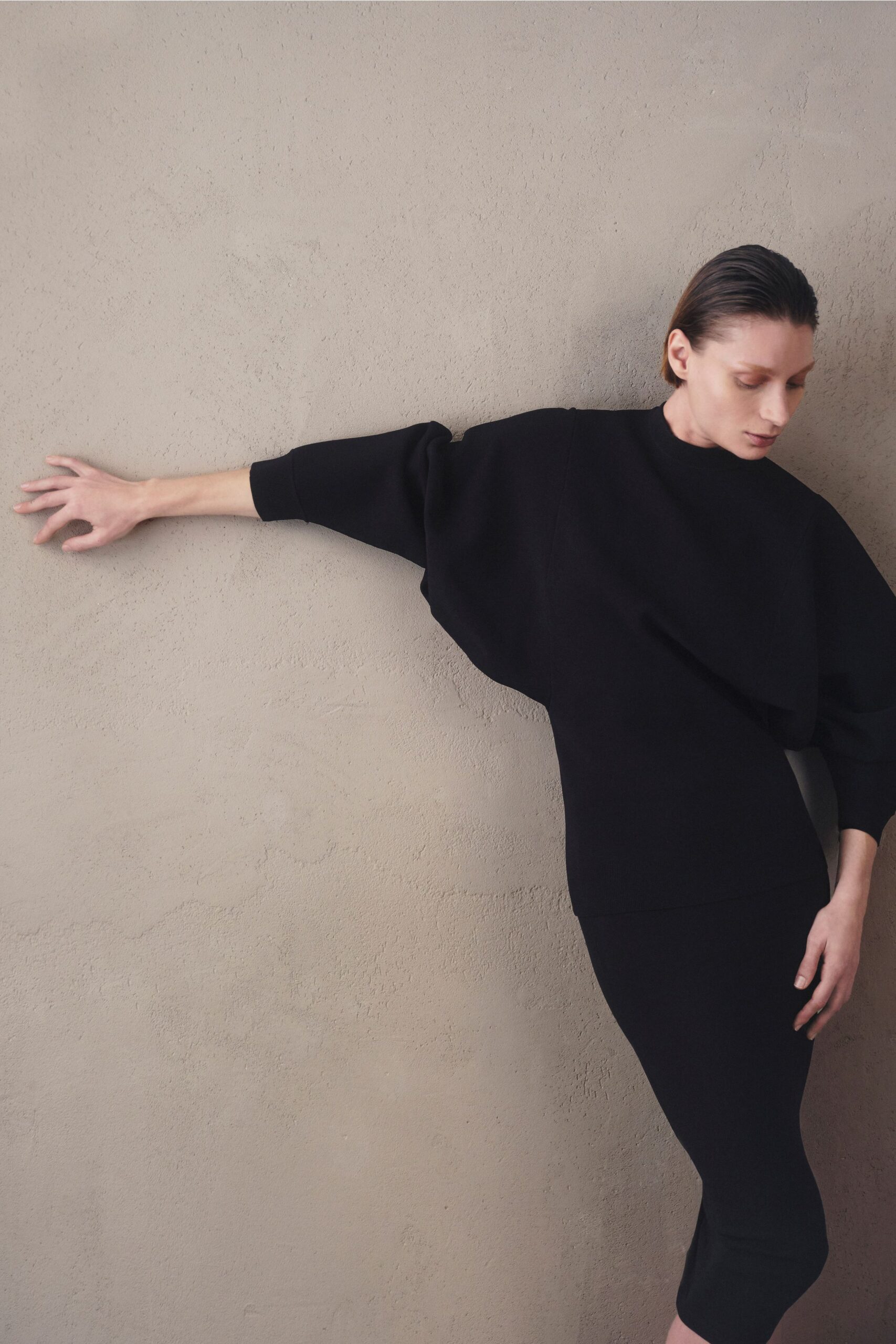 black relaxed top and fitted skirt