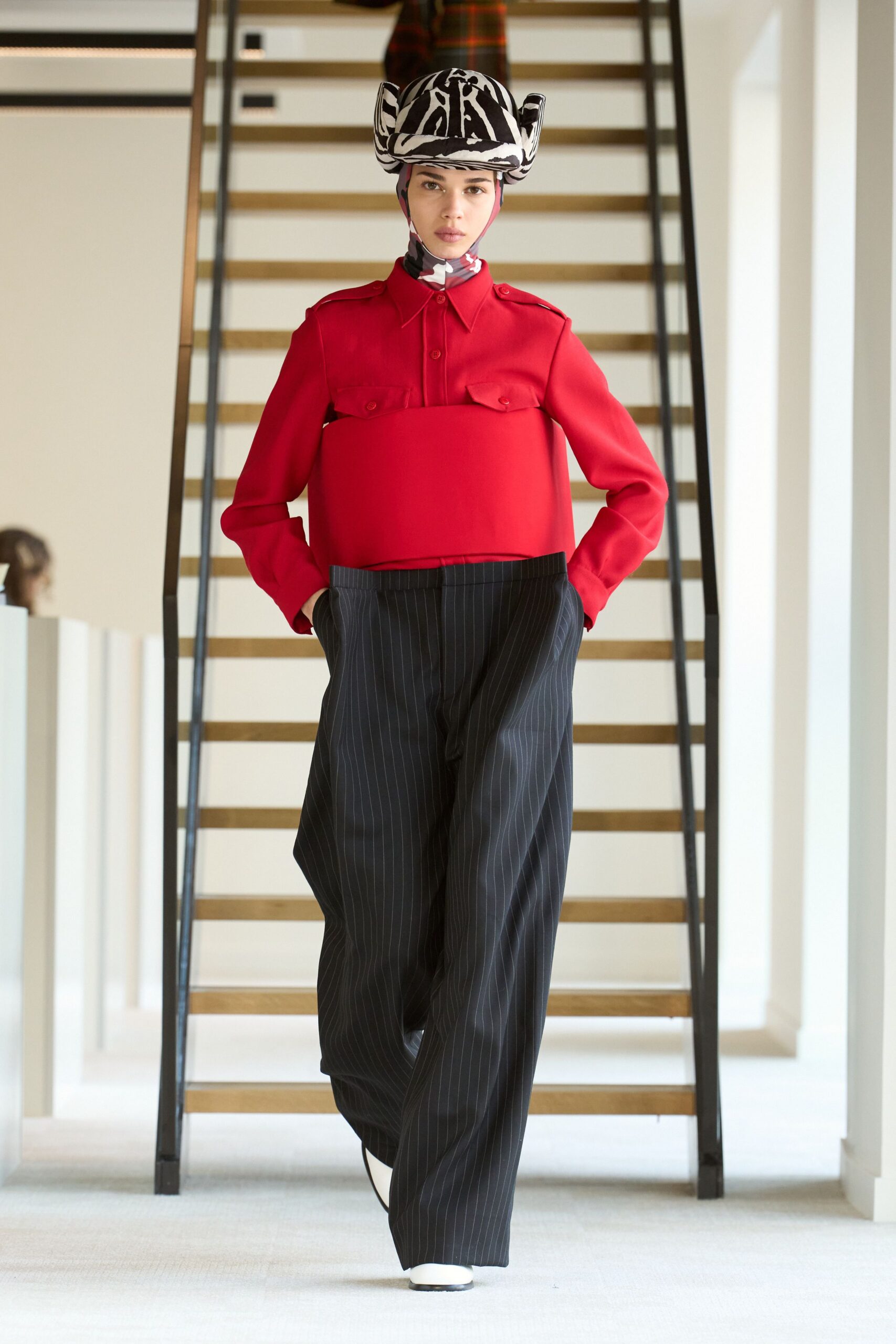 red fitted top with black pants