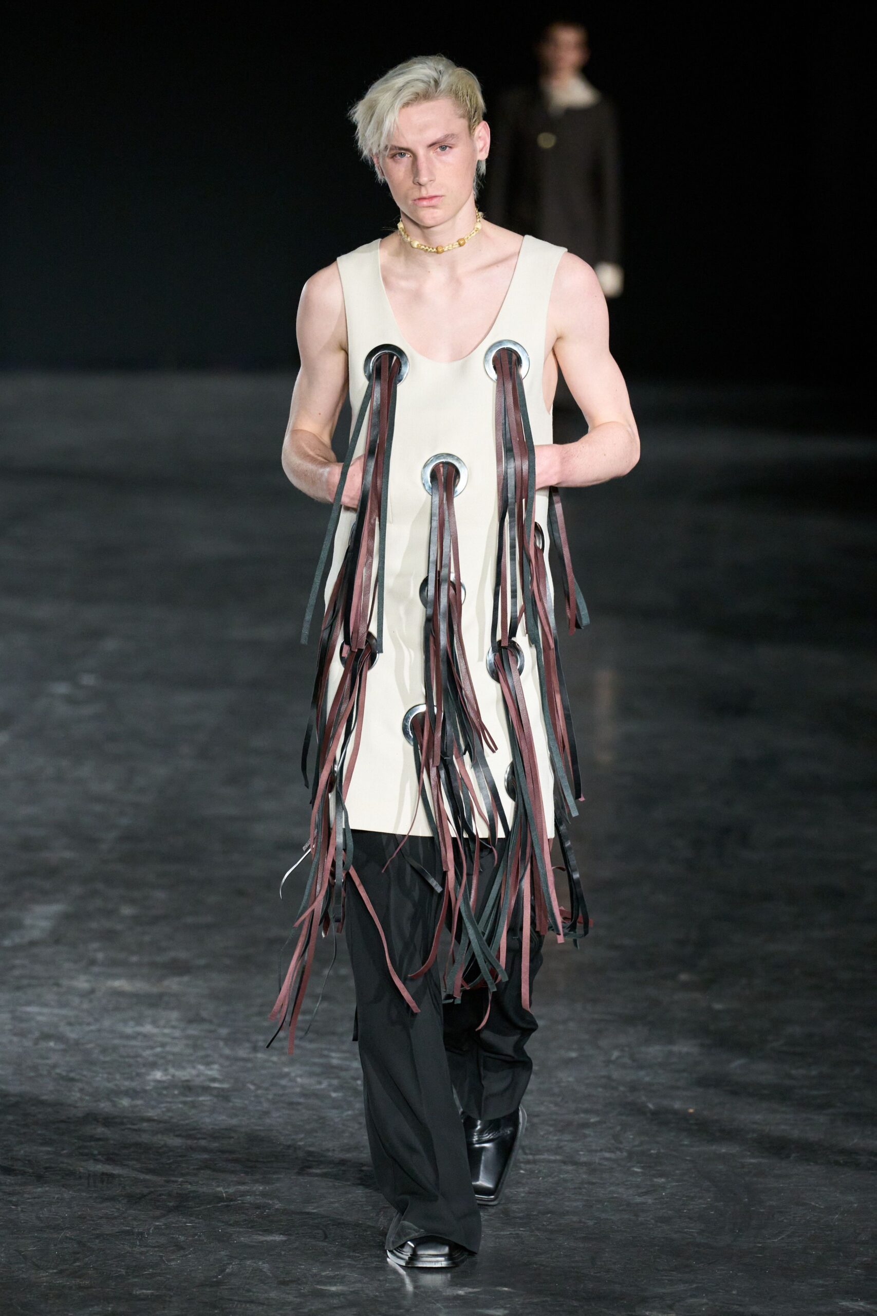 beige fringed sleeveless dress with black pants