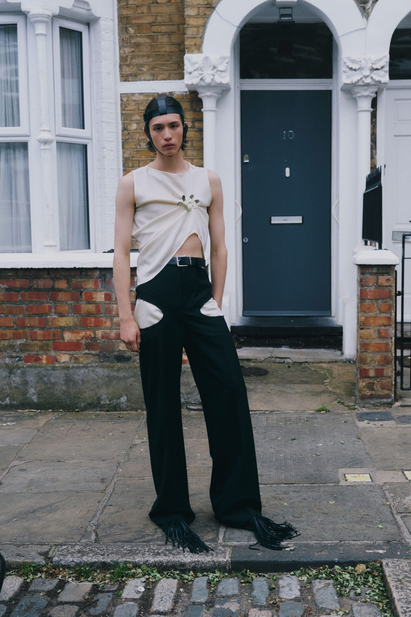 white sleeveless top black pants