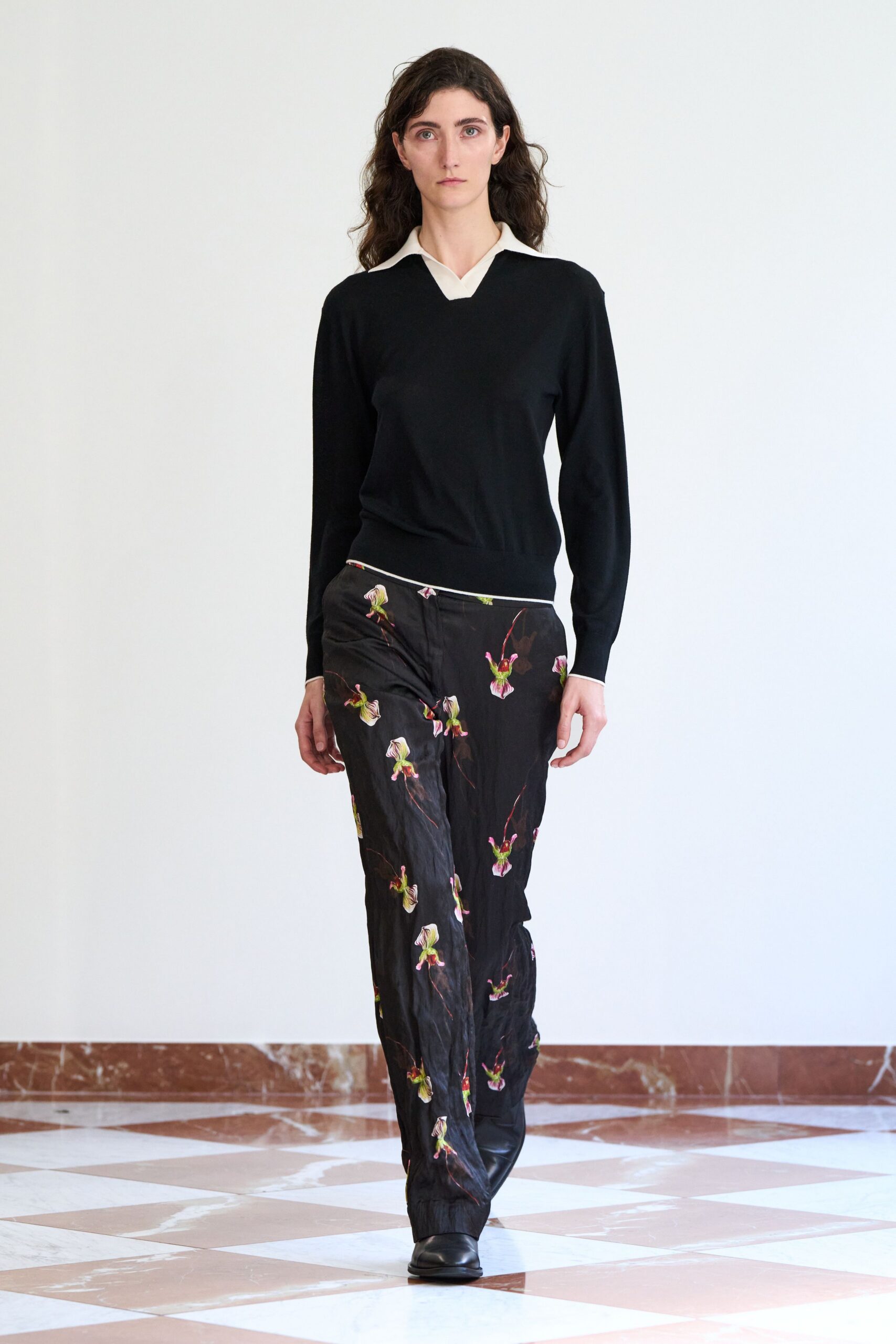 black fitted sweater and printed pants