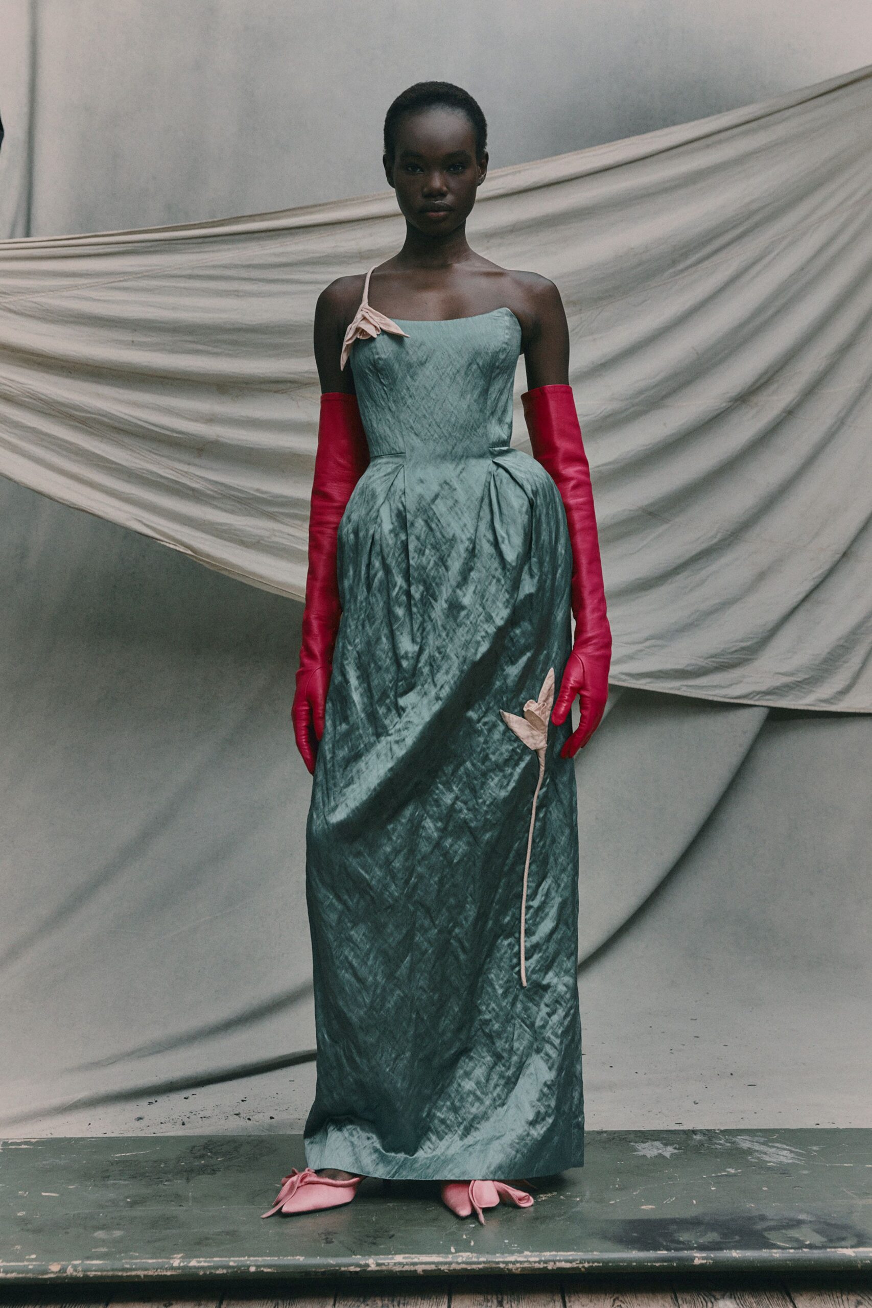 green silk sleeveless off-shoulder fitted pleated maxi gown