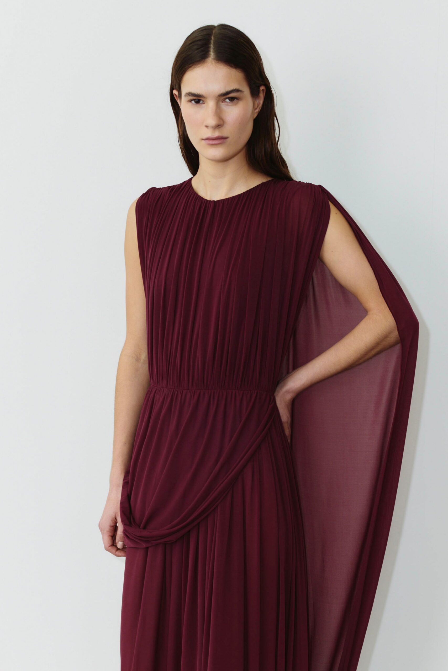 maroon pleated flowing gown