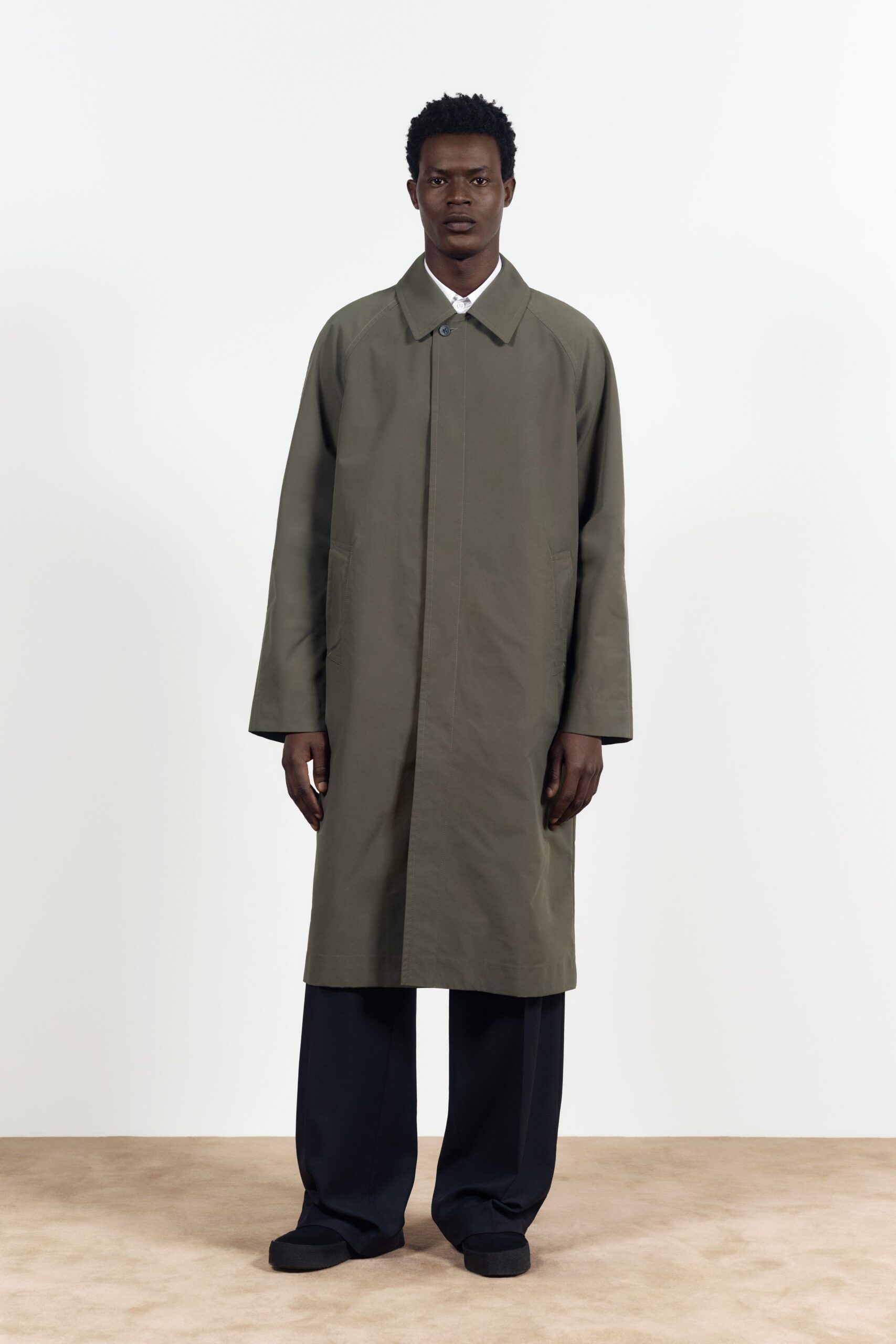 green coat black pants black shoes