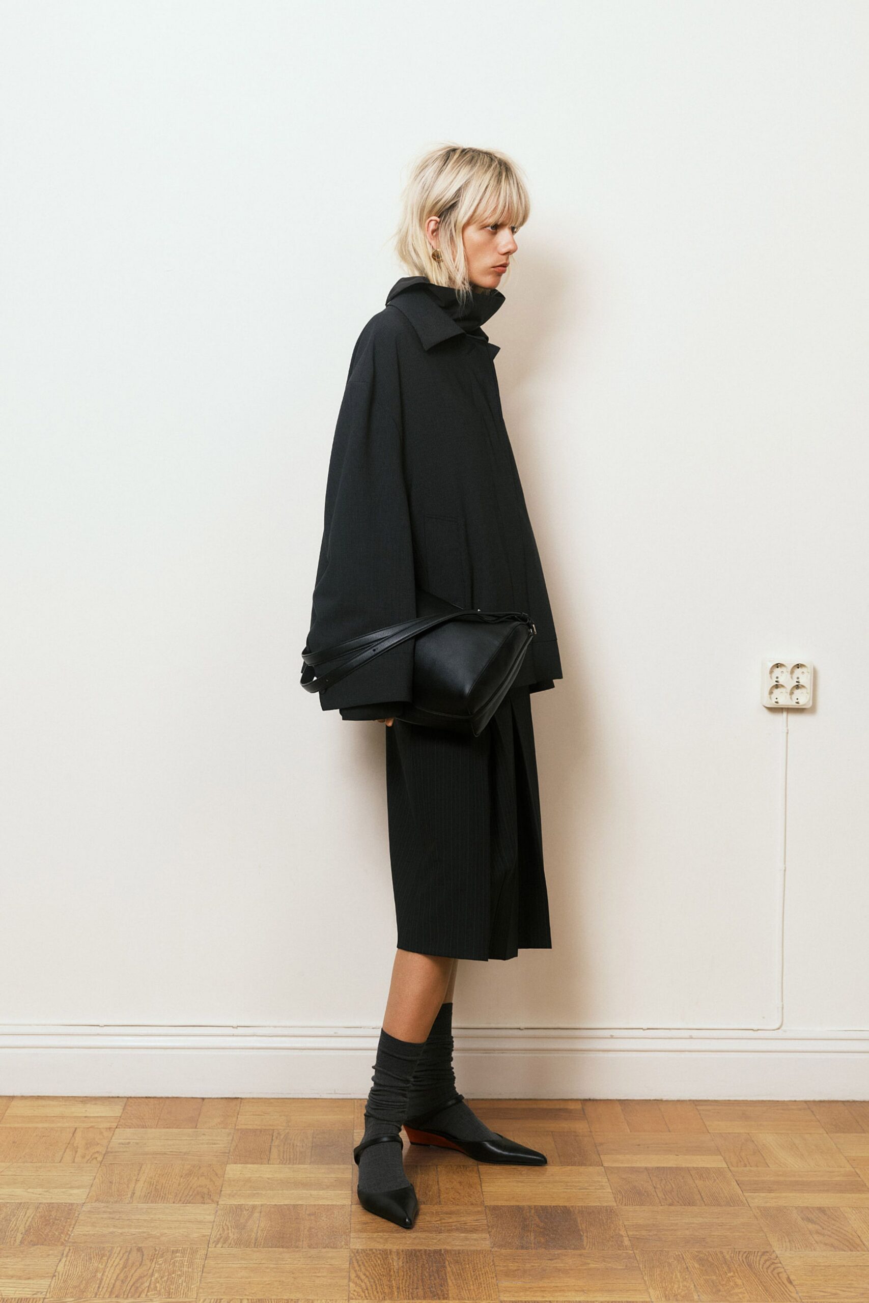 black oversized coat with pleated skirt