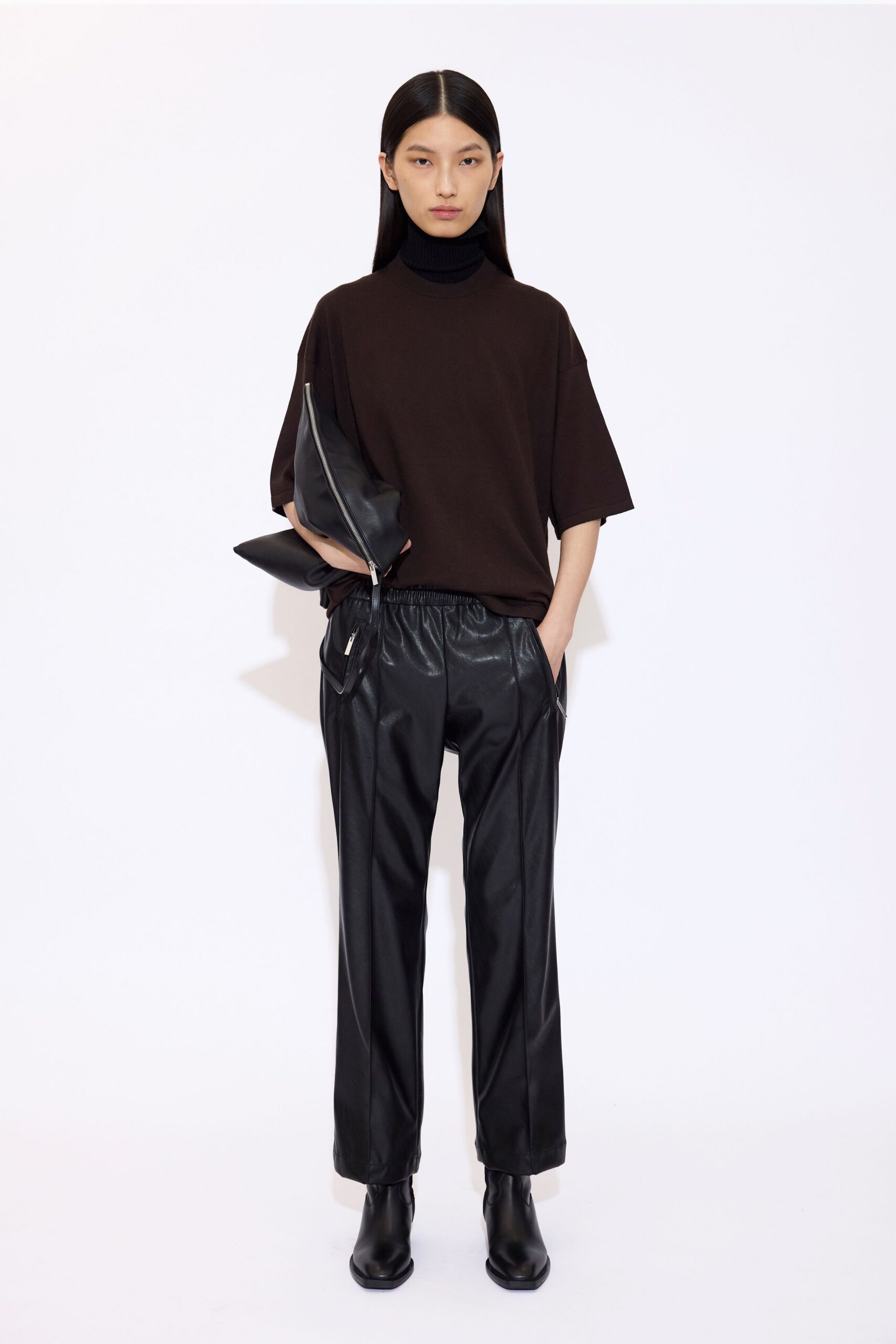 brown relaxed top with black leather pants