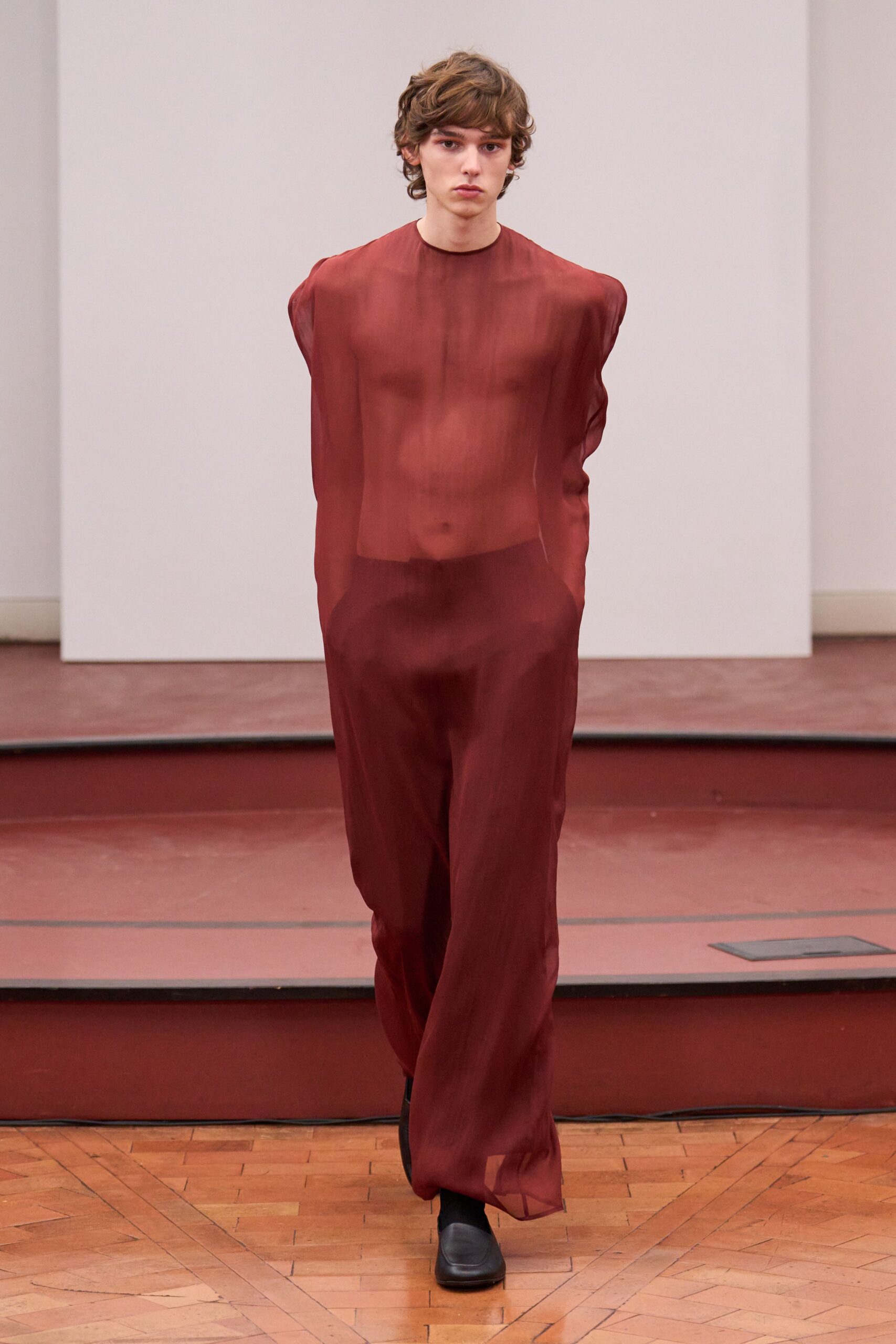 red sheer jumpsuit with black shoes