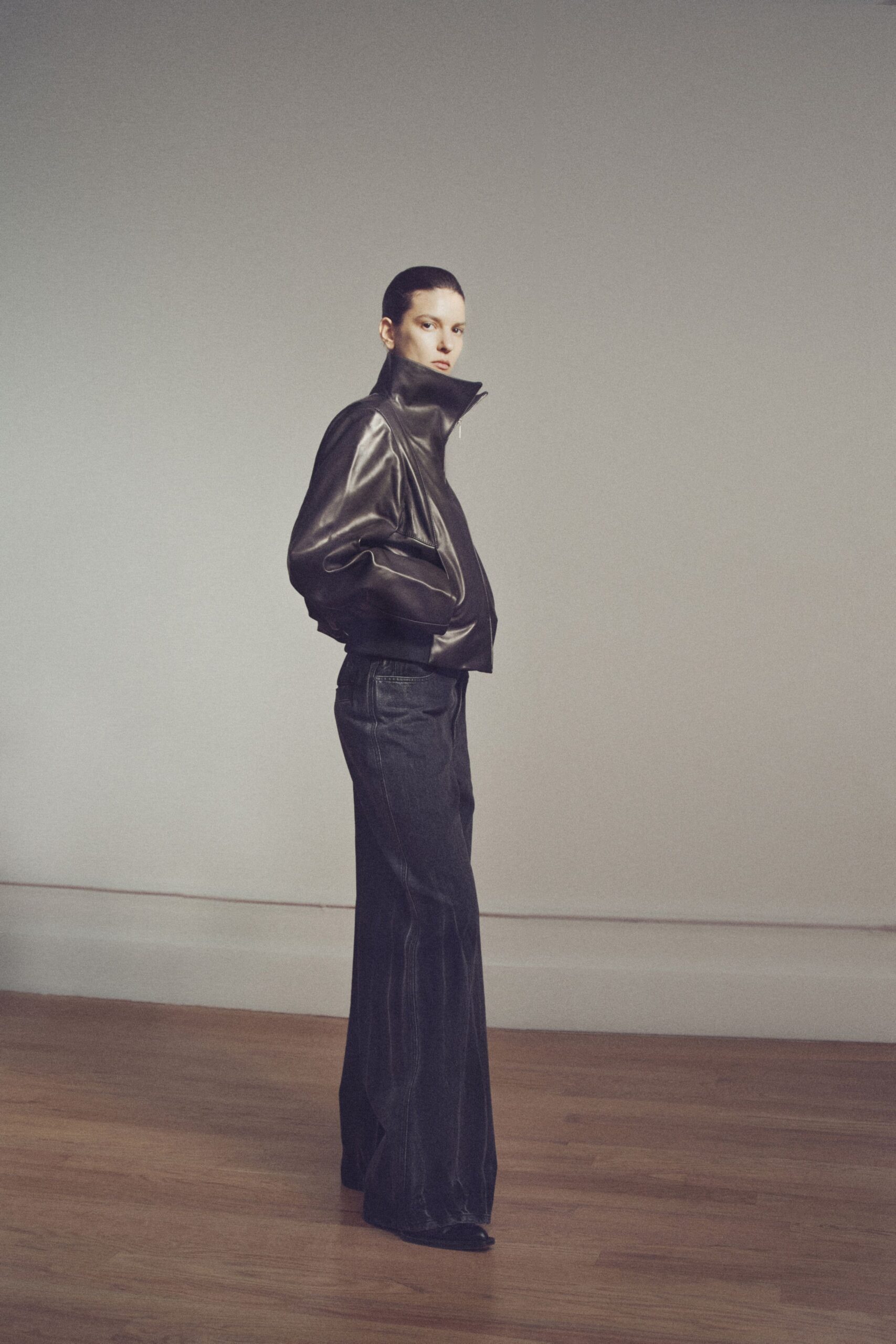 black leather fitted jacket and relaxed pants