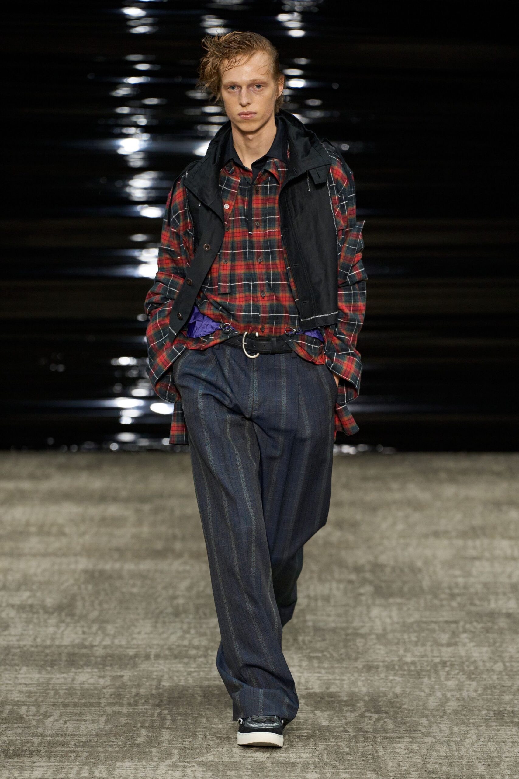 checked shirt with black vest and gray pants