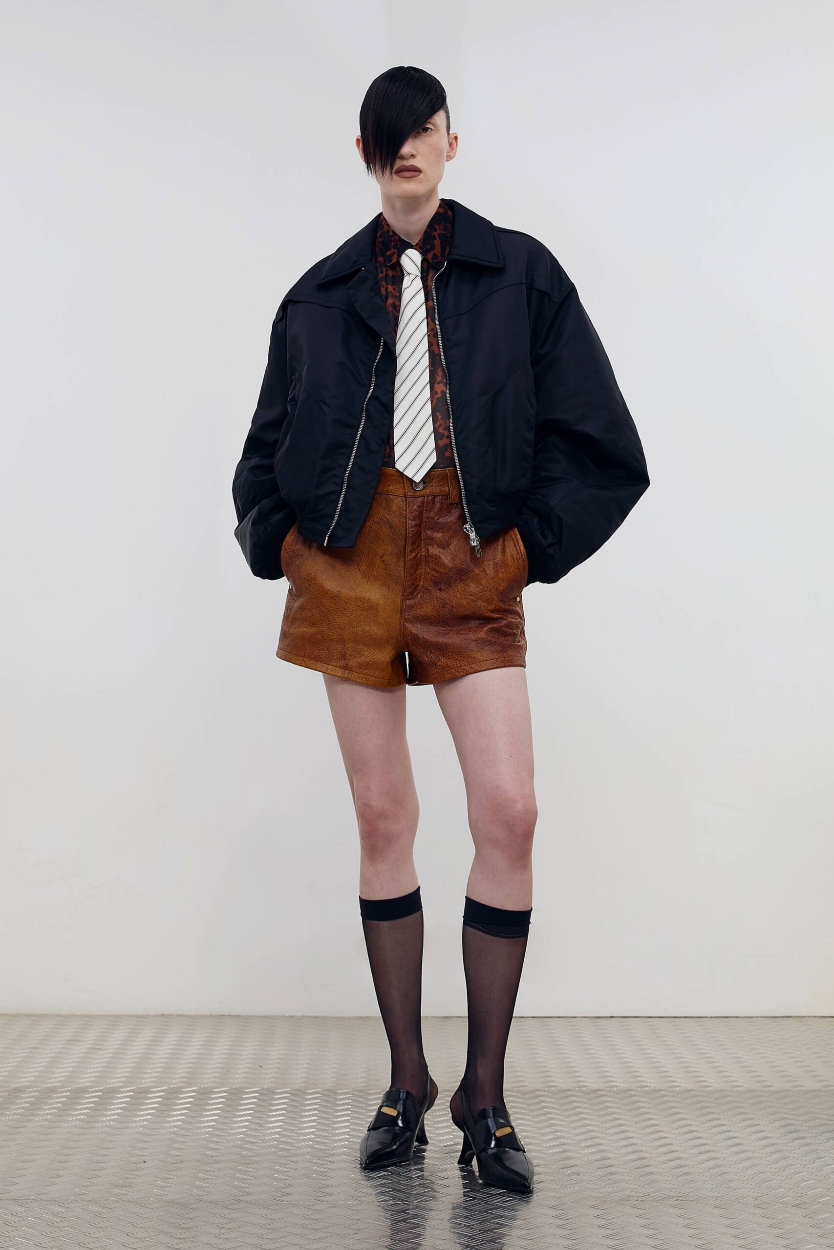 black oversized jacket with brown shorts