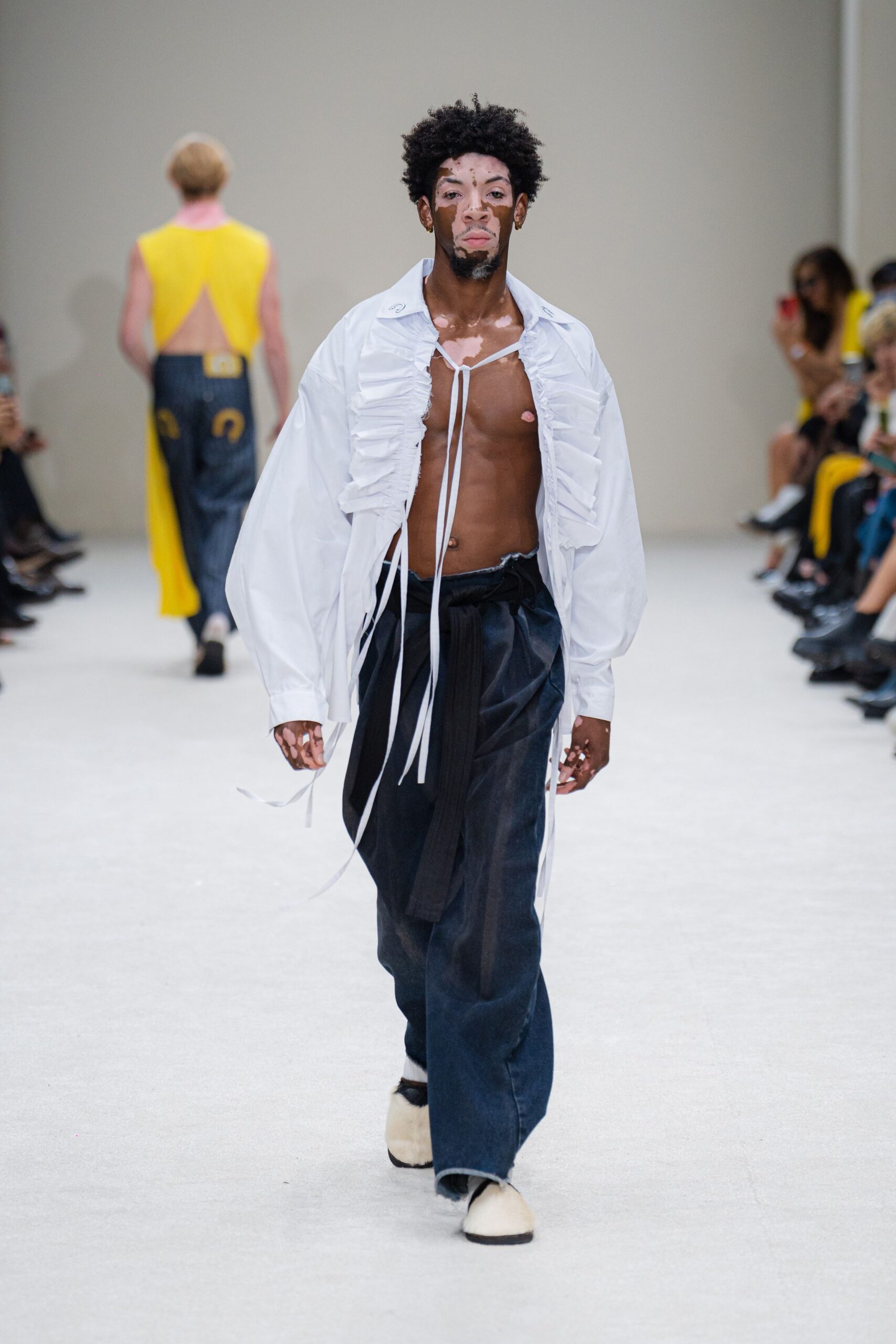 white ruffled shirt with blue pants