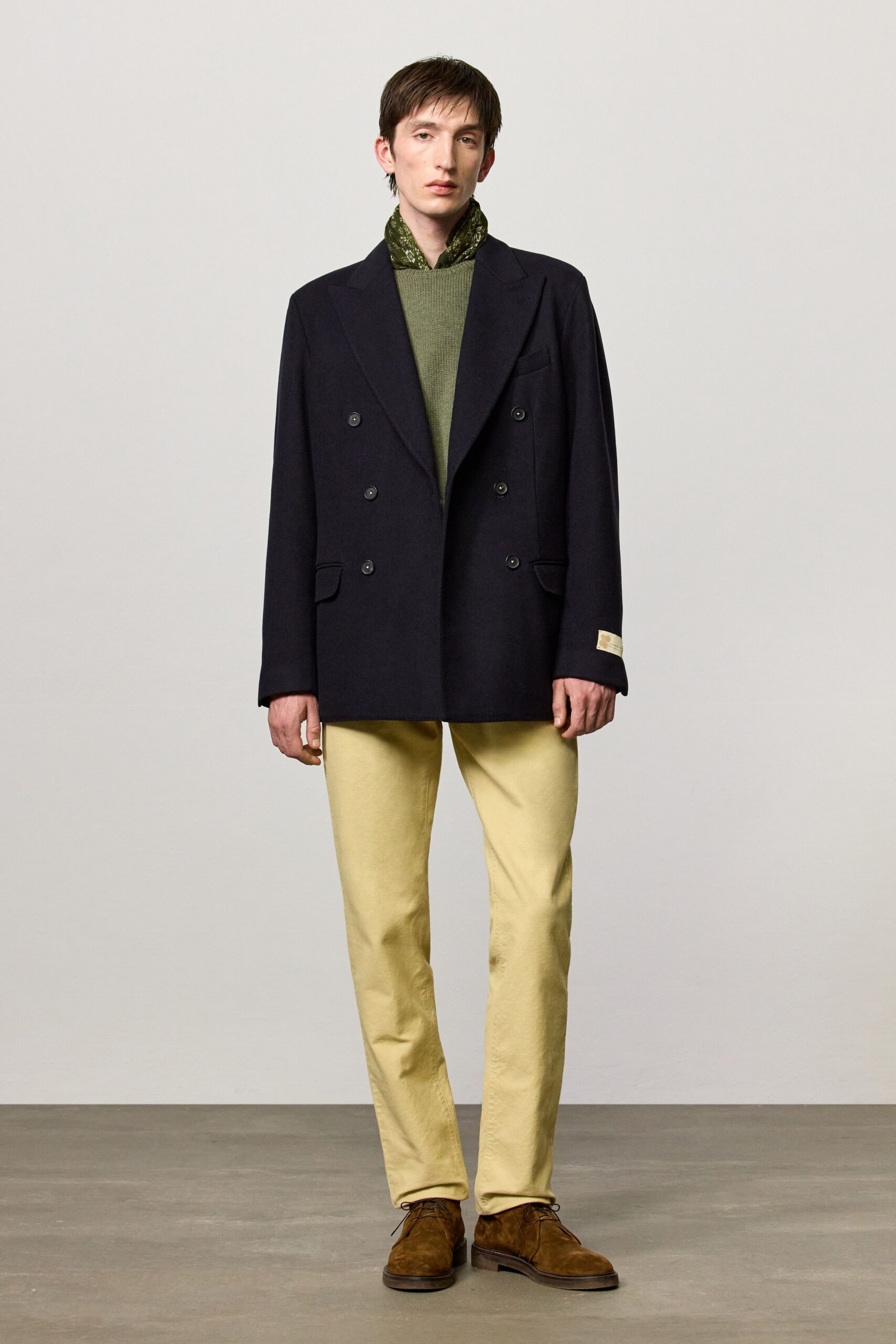black blazer green sweater beige pants