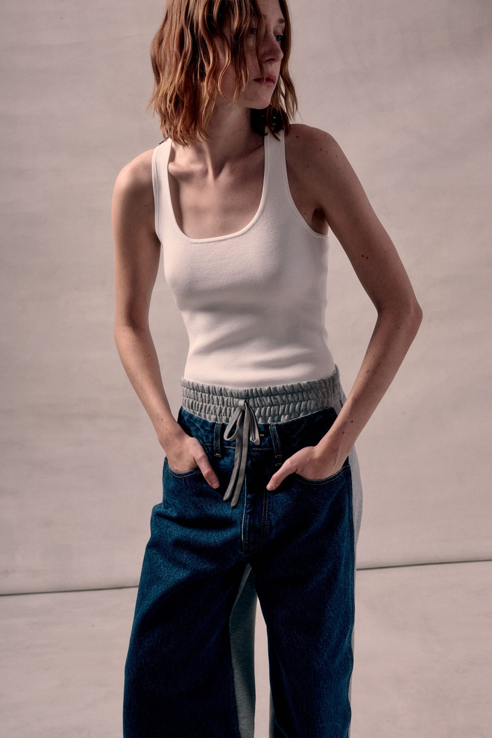 white tank-top and blue relaxed pants