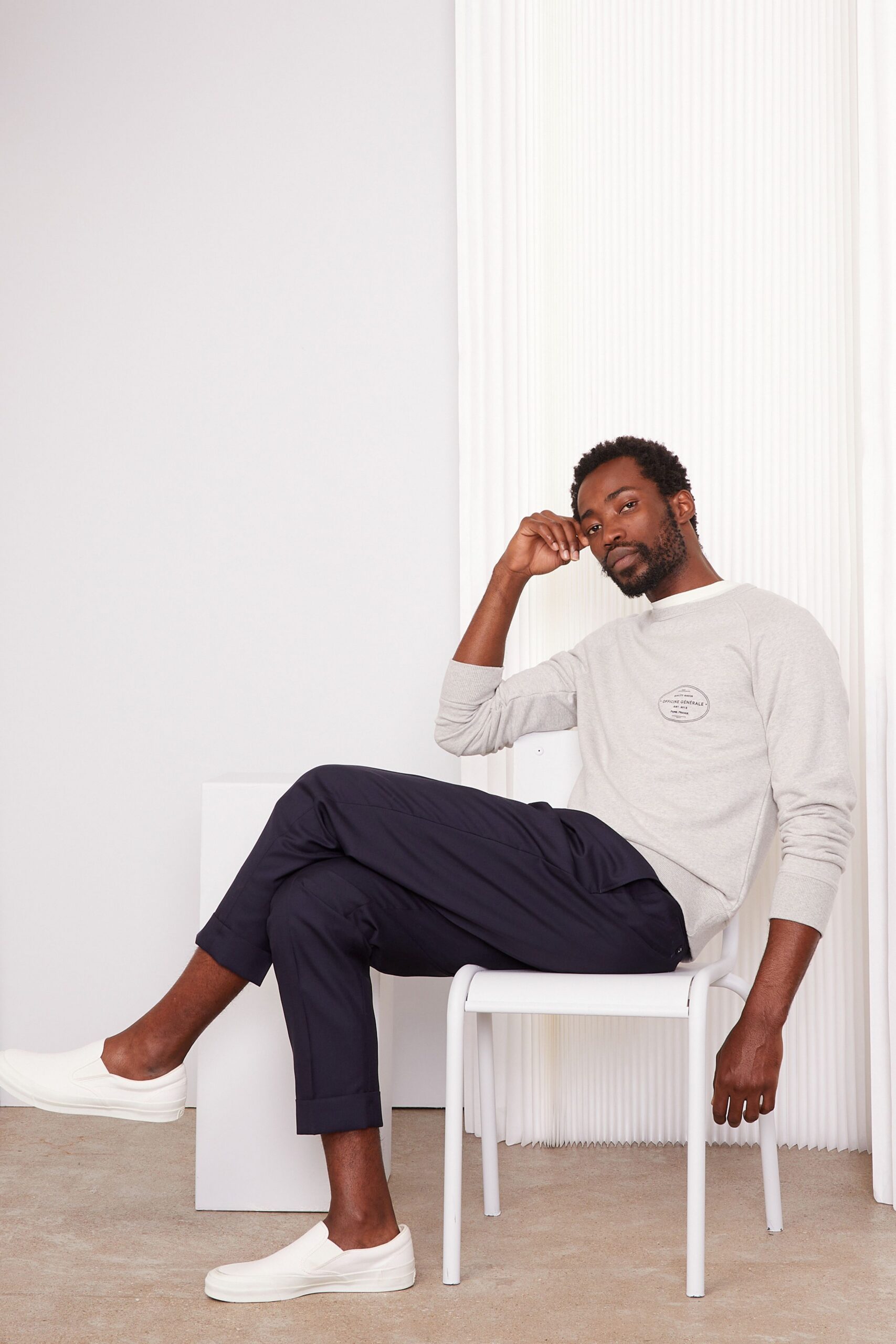 gray relaxed sweater with navy pants