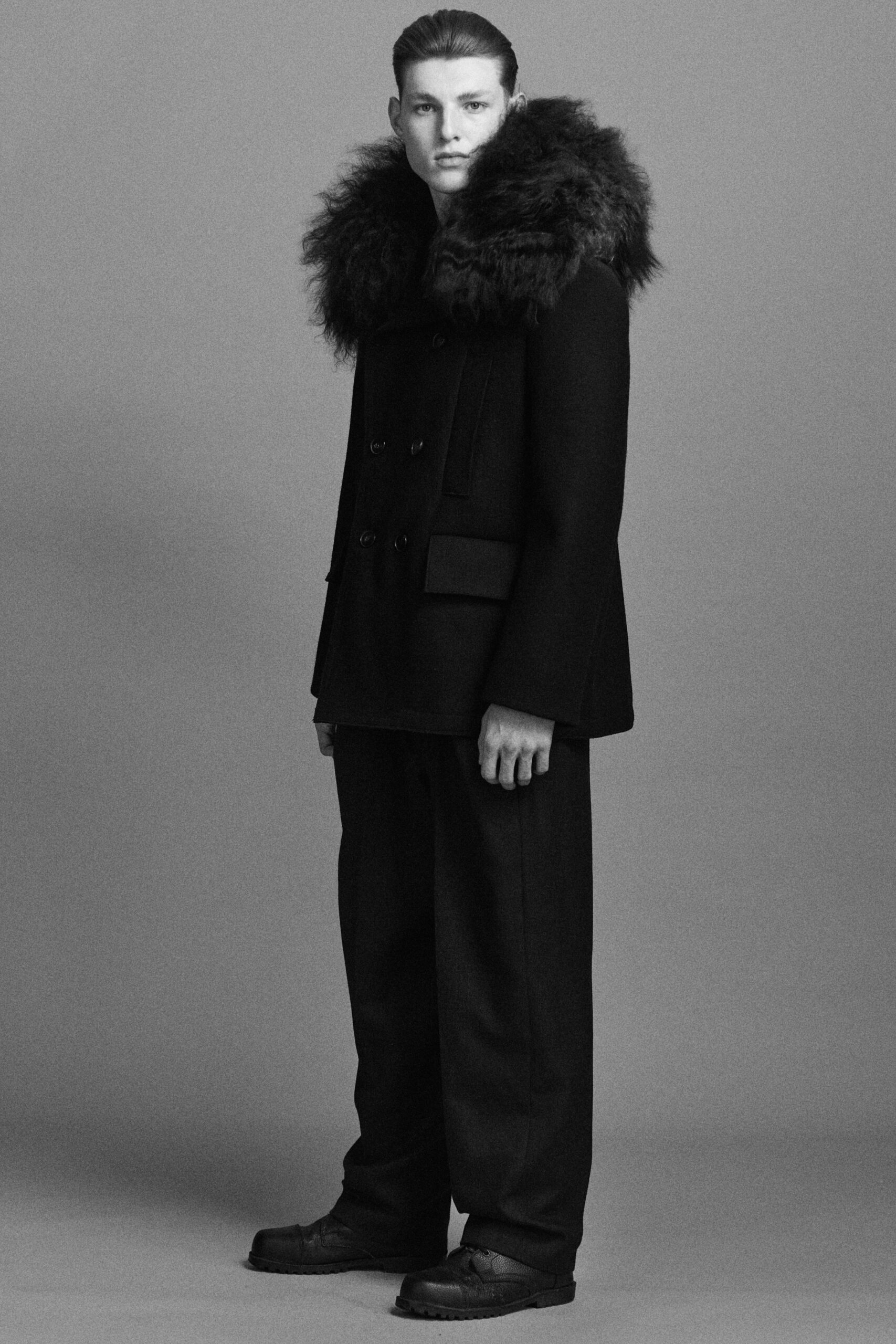 black wool long-sleeve collared structured pleated coat