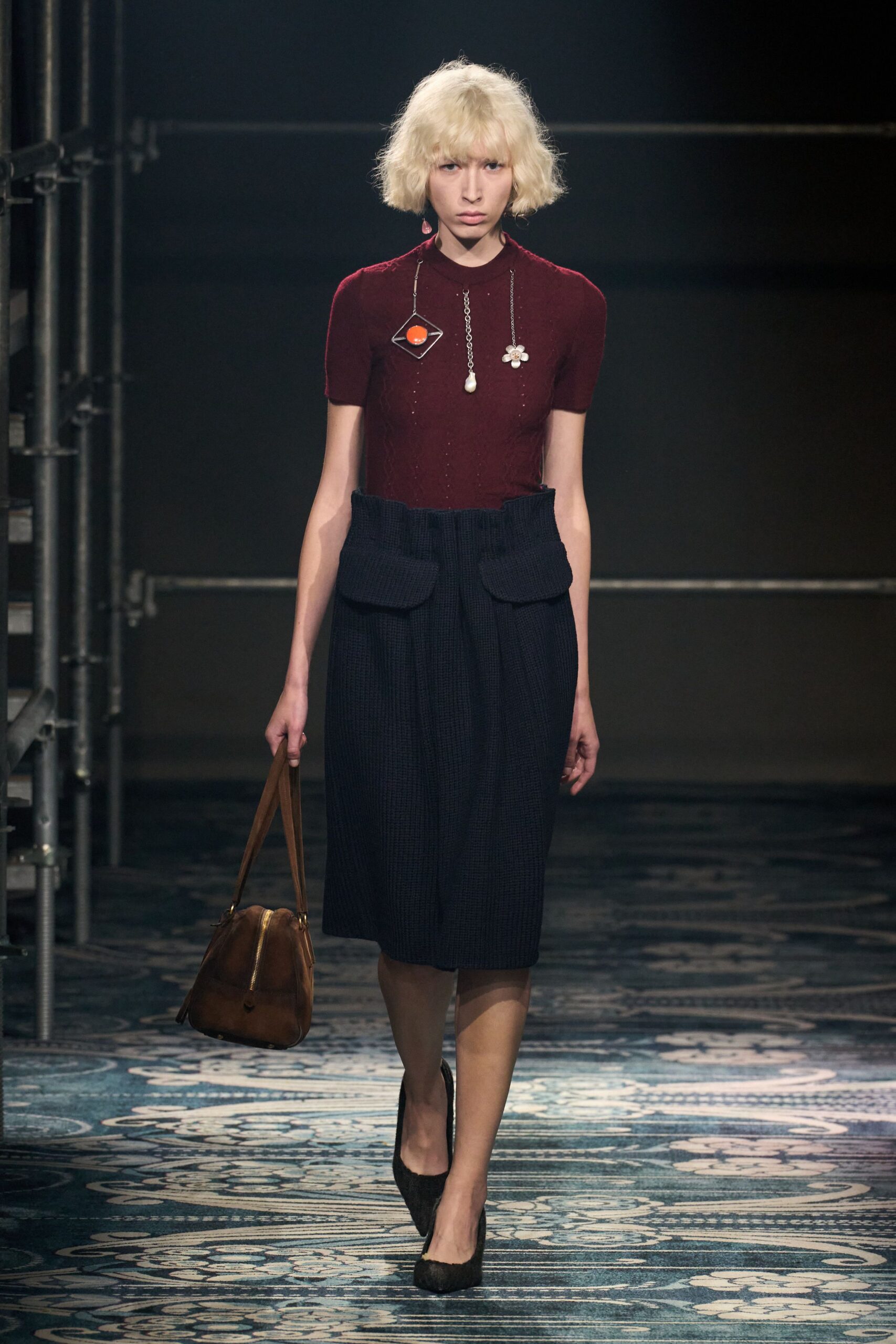 maroon fitted top with navy pleated skirt