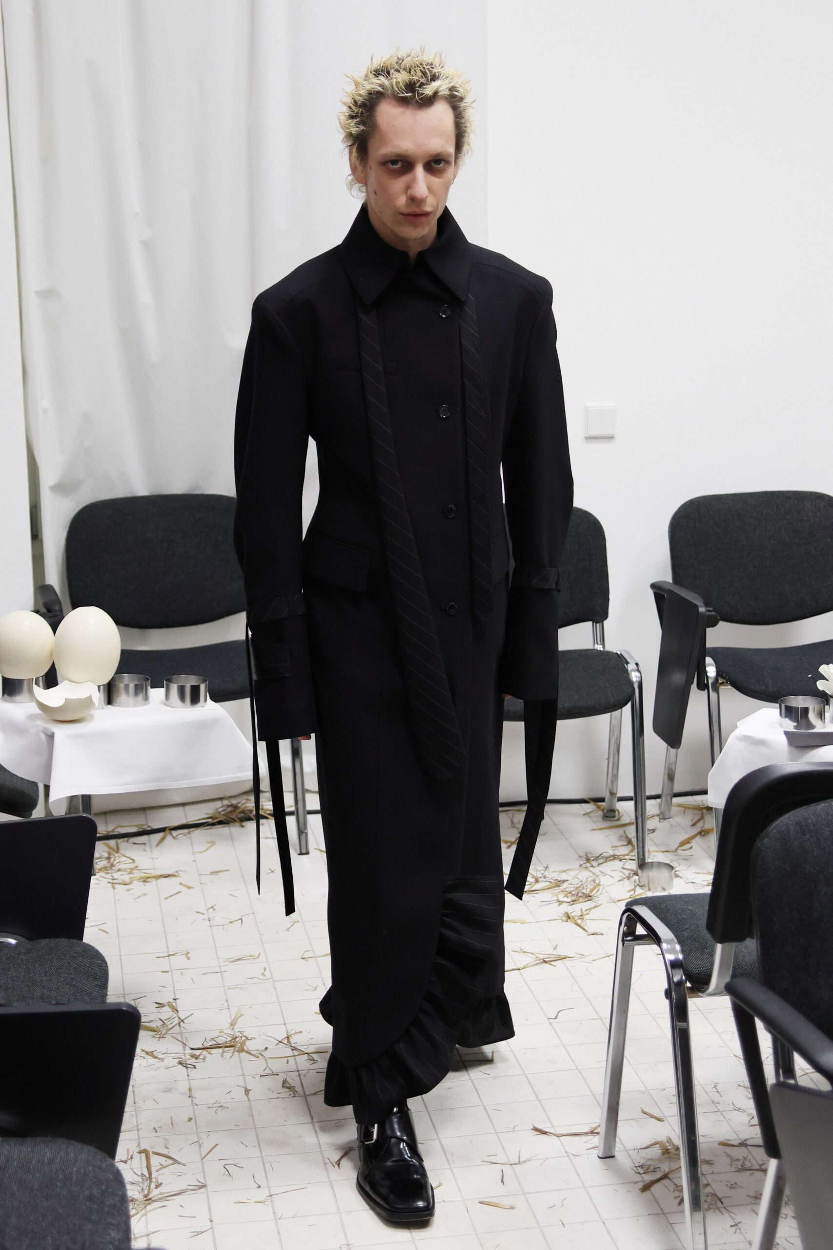 black fitted coat with pleats