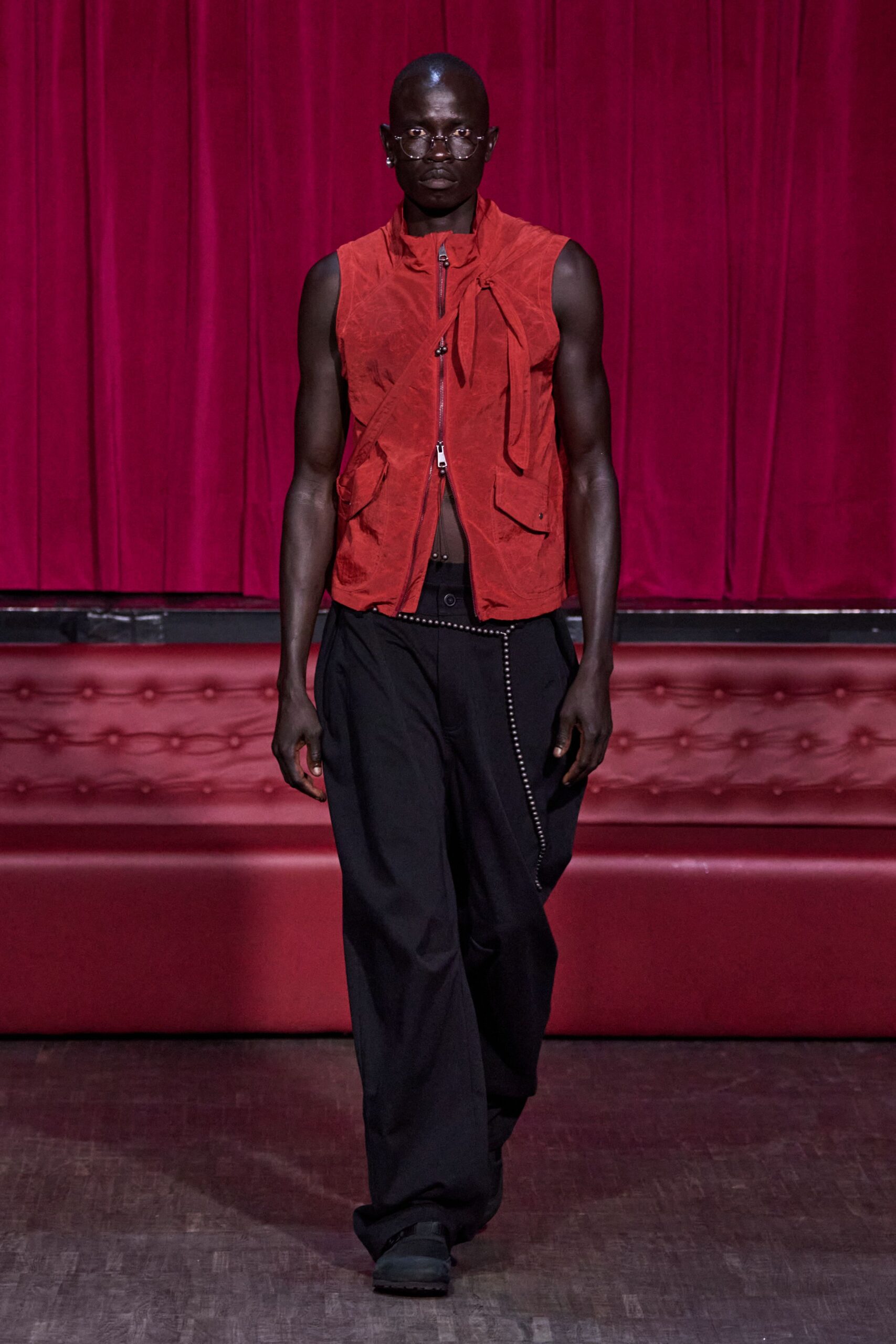red fitted vest with black pants