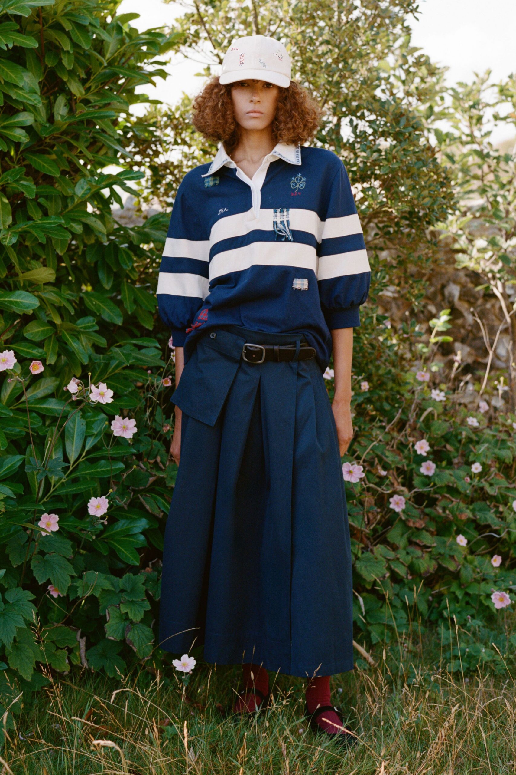 blue and white relaxed shirt with navy pleated skirt