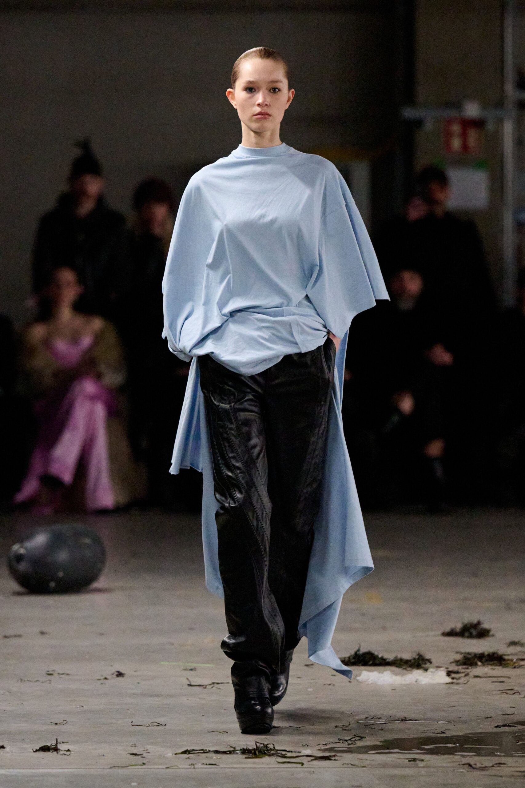 blue relaxed top with black leather pants